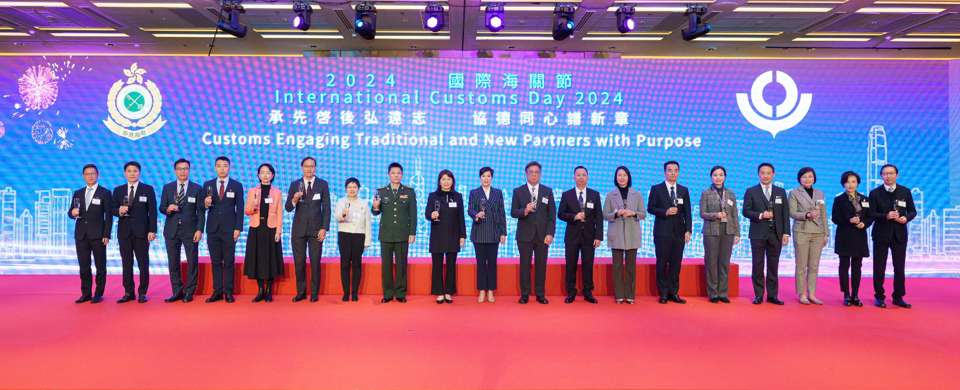 The Director of Public Prosecutions, Ms Maggie Yang (ninth left), and the Commissioner of Customs and Excise, Ms Louise Ho (centre), proposed a toast at a reception in celebration of International Customs Day 2024 today (January 25). Joining them are the Secretary for Commerce and Economic Development, Mr Algernon Yau (ninth right); the Chinese People's Liberation Army Hong Kong Garrison, Senior Colonel Qi Xiaochun (eighth left); the Director-General of Macao Customs Service, Mr Vong Man-chong (eighth right); the Acting Head of the Commercial Office of the Economic Affairs Department of the LOCPG in the HKSAR, Ms Chen Jiarong (seventh left); the Deputy Secretary for Financial Services and the Treasury, Ms Manda Chan (seventh right); the Commissioner for Narcotics of the Narcotics Division of the Security Bureau, Mr Kesson Lee (sixth left); the Director of the Liaison Office of the Office for Safeguarding National Security of the CPG in the HKSAR, Mr Zhang Jianfeng (sixth right); the Director-General of the Department of Treaty and Law of the Office of the Commissioner of the Ministry of Foreign Affairs of the People's Republic of China in the HKSAR, Ms Zhou Qian (fifth left); the Deputy Director of Executive Office of the Guangdong Sub-Administration of the General Administration of Customs of the People's Republic of China, Ms Wu Siliu (fifth right); the Analyst at Level 3 of the Police Liaison Department of the Liaison Office of the CPG in the HKSAR, Mr Qiu Guobin (fourth left); and the directorates of Hong Kong Customs.
