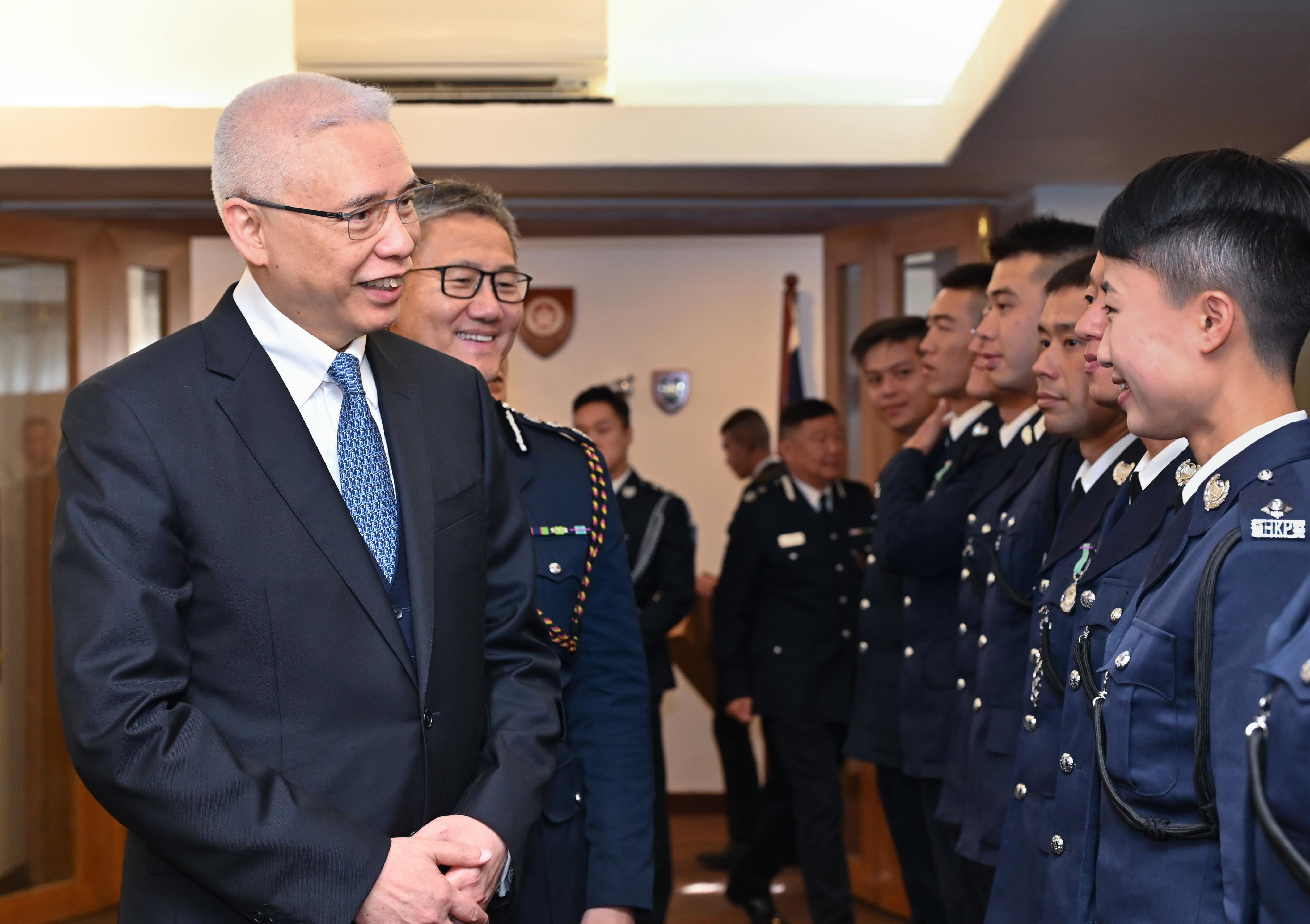 The Non-executive Chairman of MTR Corporation Limited, Dr Rex Auyeung Pak-kuen (first left), and the Commissioner of Police, Mr Siu Chak-yee (second left) congratulate the probationary inspectors after the passing-out parade held at the Hong Kong Police College today (February 3).