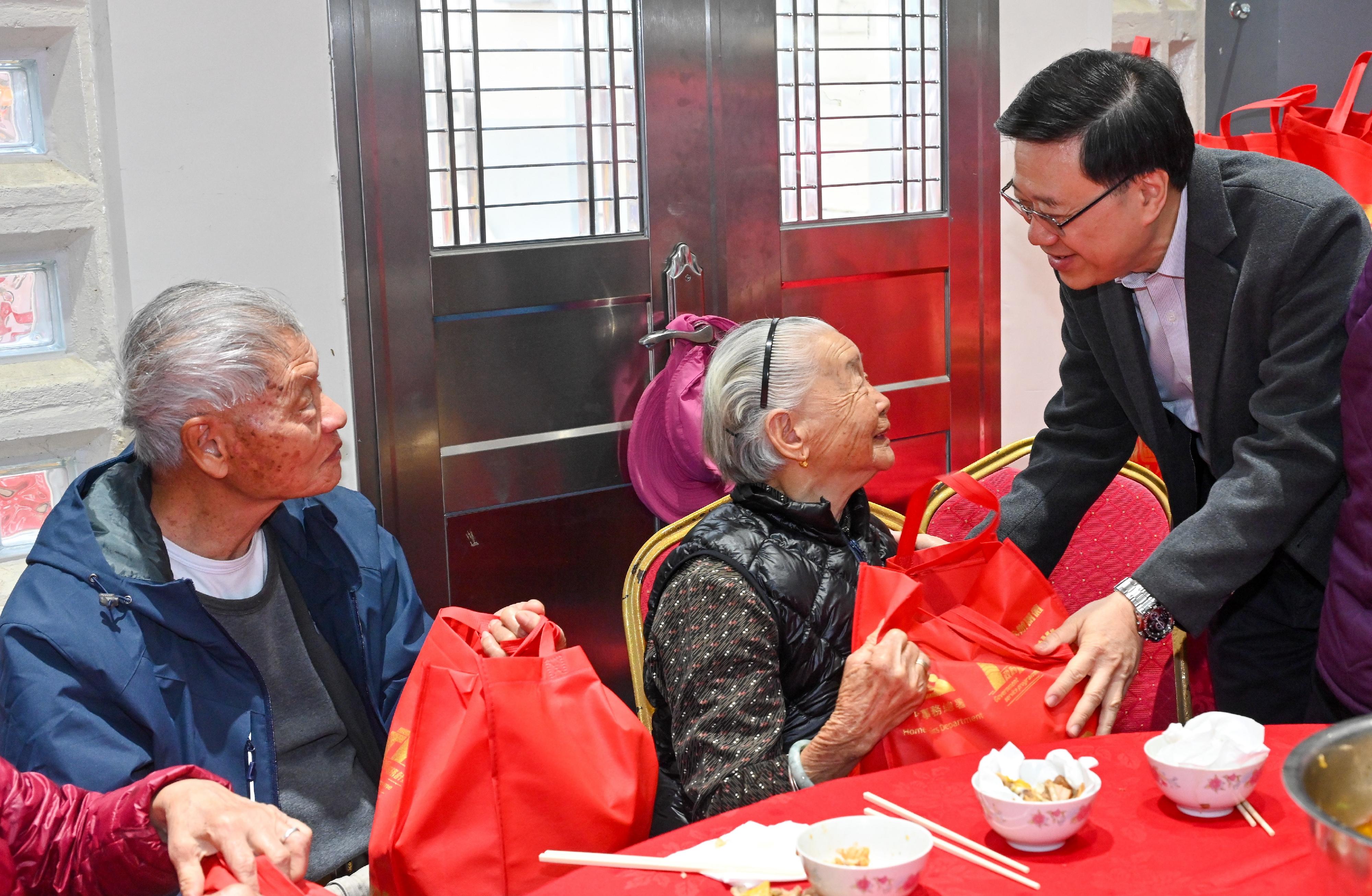 行政长官李家超今日（二月七日）到访大埔区。图示李家超（右一）向长者派发新春福袋。
