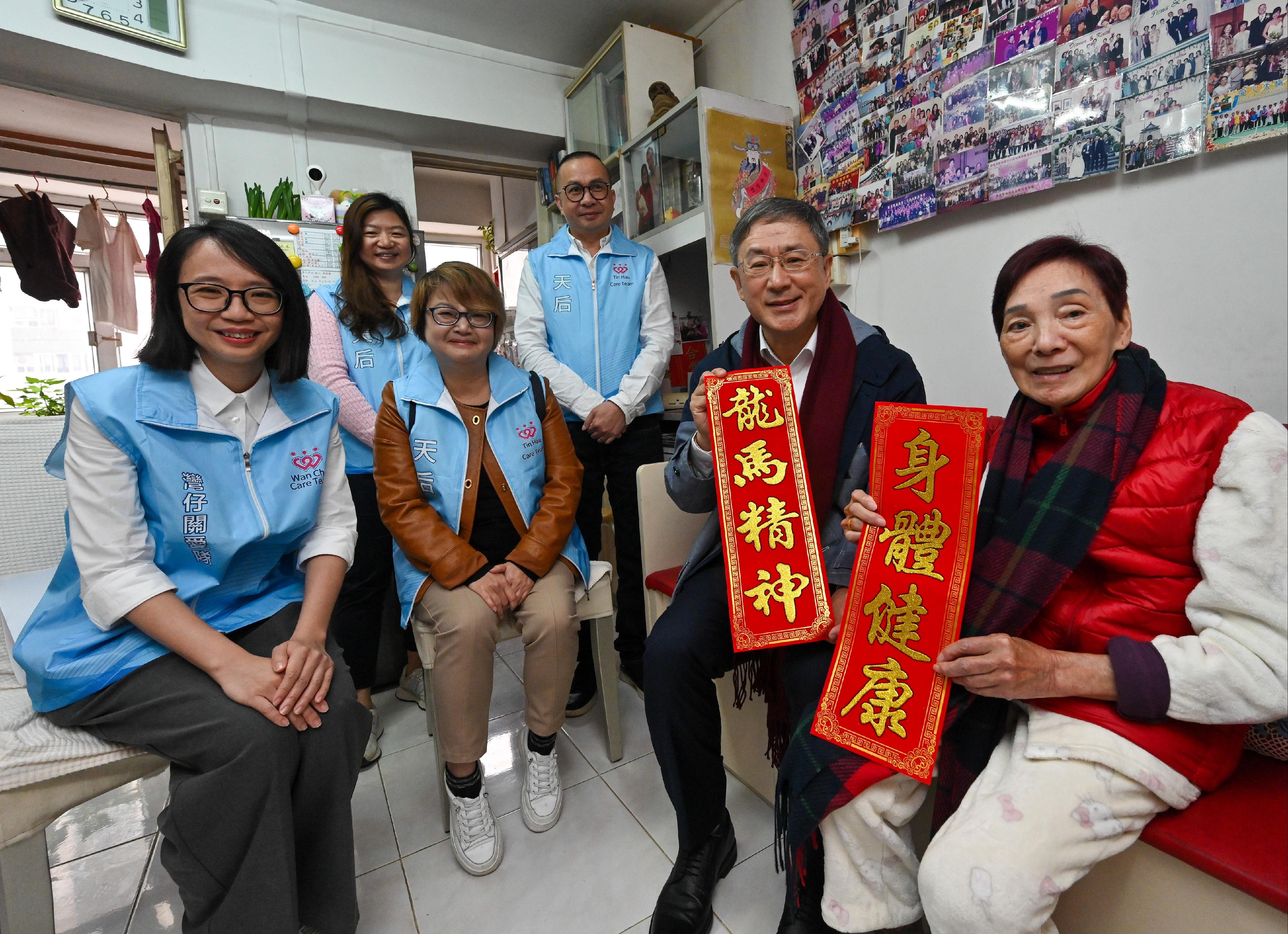 The Deputy Chief Secretary for Administration, Mr Cheuk Wing-hing (second right), today (February 8) visited elderly households living in Lai Tak Tsuen to extend his care and regards, and share with them the festive joy. Joining Mr Cheuk are the District Officer (Wan Chai), Ms Fanny Cheung (first left), Wan Chai District Council members Ms Lau Pui-shan (second left) and Mr Joey Lee (back row, right) and representatives from the Care Team (Wan Chai).