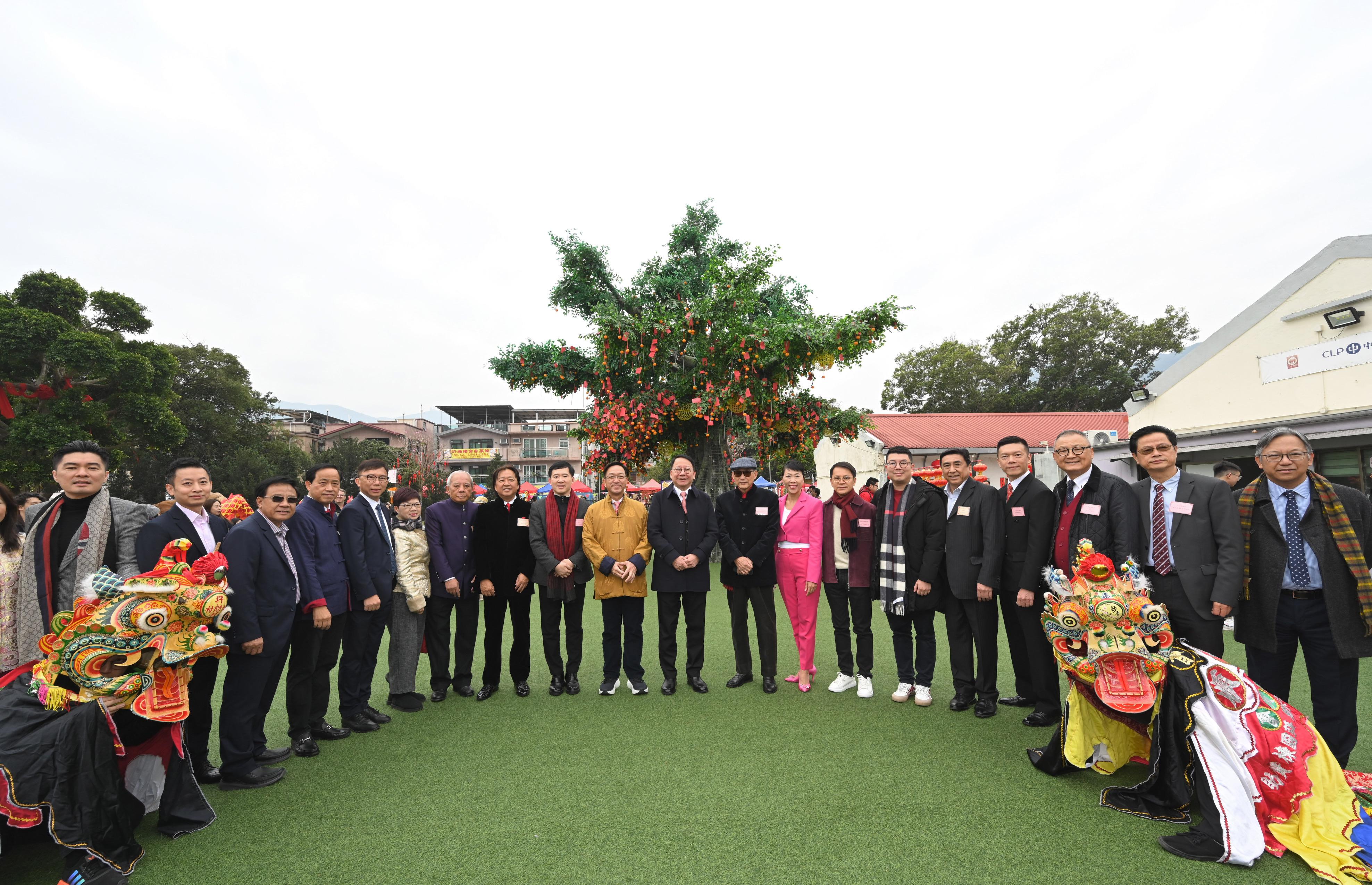 The Chief Secretary for Administration, Mr Chan Kwok-ki, attends the Hong Kong Well-wishing Festival 2024 at Lam Tsuen, Tai Po, today (February 10), on the first day of the Lunar New Year. Photo shows Mr Chan (tenth right); the initiator of the Hong Kong Well-wishing Festival, Mr Cheung Hok-ming (ninth right); the Chairman of the Heung Yee Kuk New Territories, Mr Kenneth Lau (tenth left), and other guests at the event.