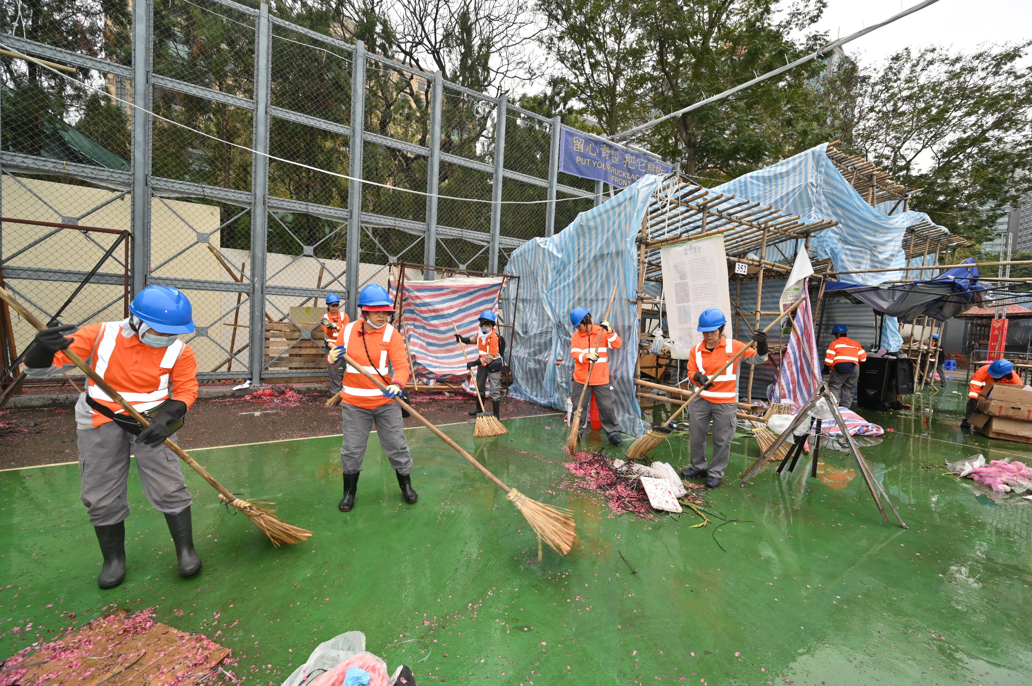 The 2024 Lunar New Year (LNY) fairs concluded successfully at 7am today (February 10). Photo shows cleansing workers cleaning up the Victoria Park LNY Fair site after the fair ended.