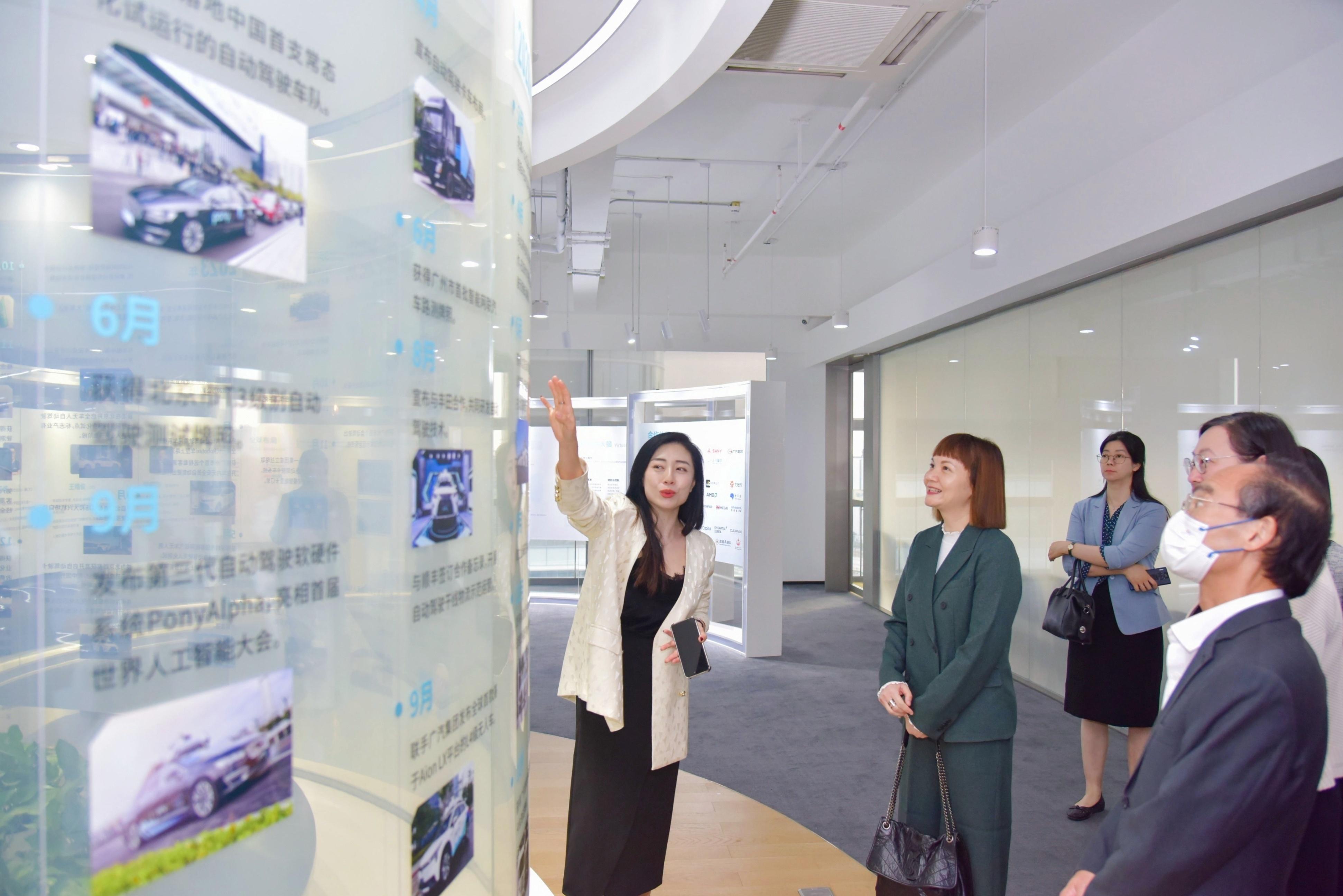 The Commissioner for the Development of the Guangdong-Hong Kong-Macao Greater Bay Area, Ms Maisie Chan, visited Guangzhou today (February 22). Photo shows Ms Chan (second left) visiting a high and new technology enterprise that specialises in autonomous vehicle technology to learn about the latest developments of the industry.