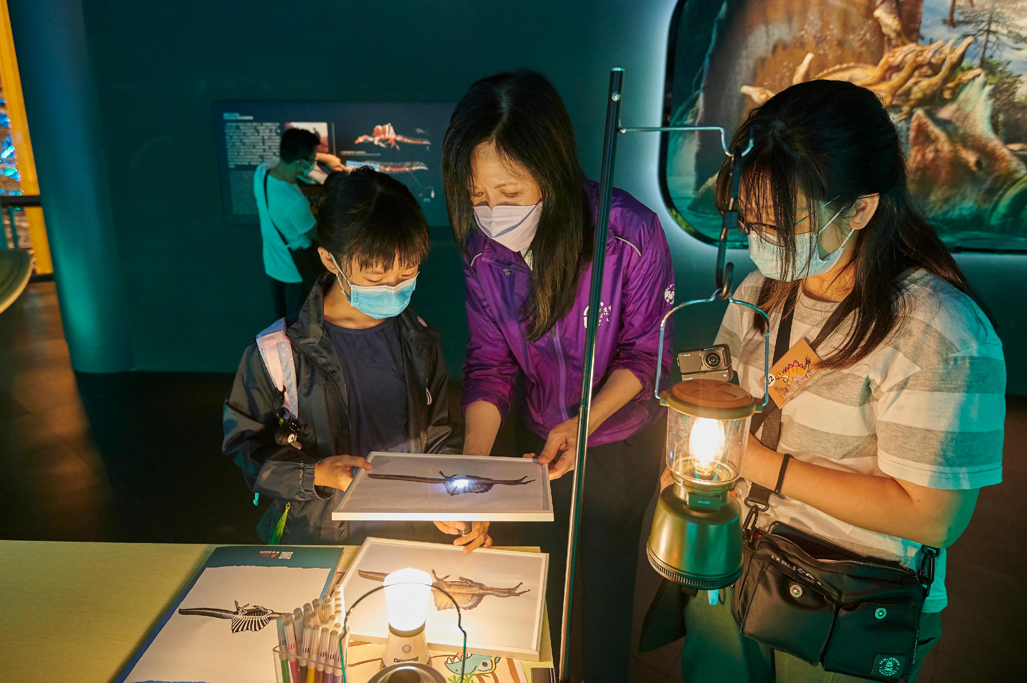 The Leisure and Cultural Services Department (LCSD) will start recruiting museum volunteers in March to serve in museums under the LCSD in various aspects. Photo shows a volunteer assisting participants in the A Night with Dinosaurs sleepover programme held at the Hong Kong Science Museum.
