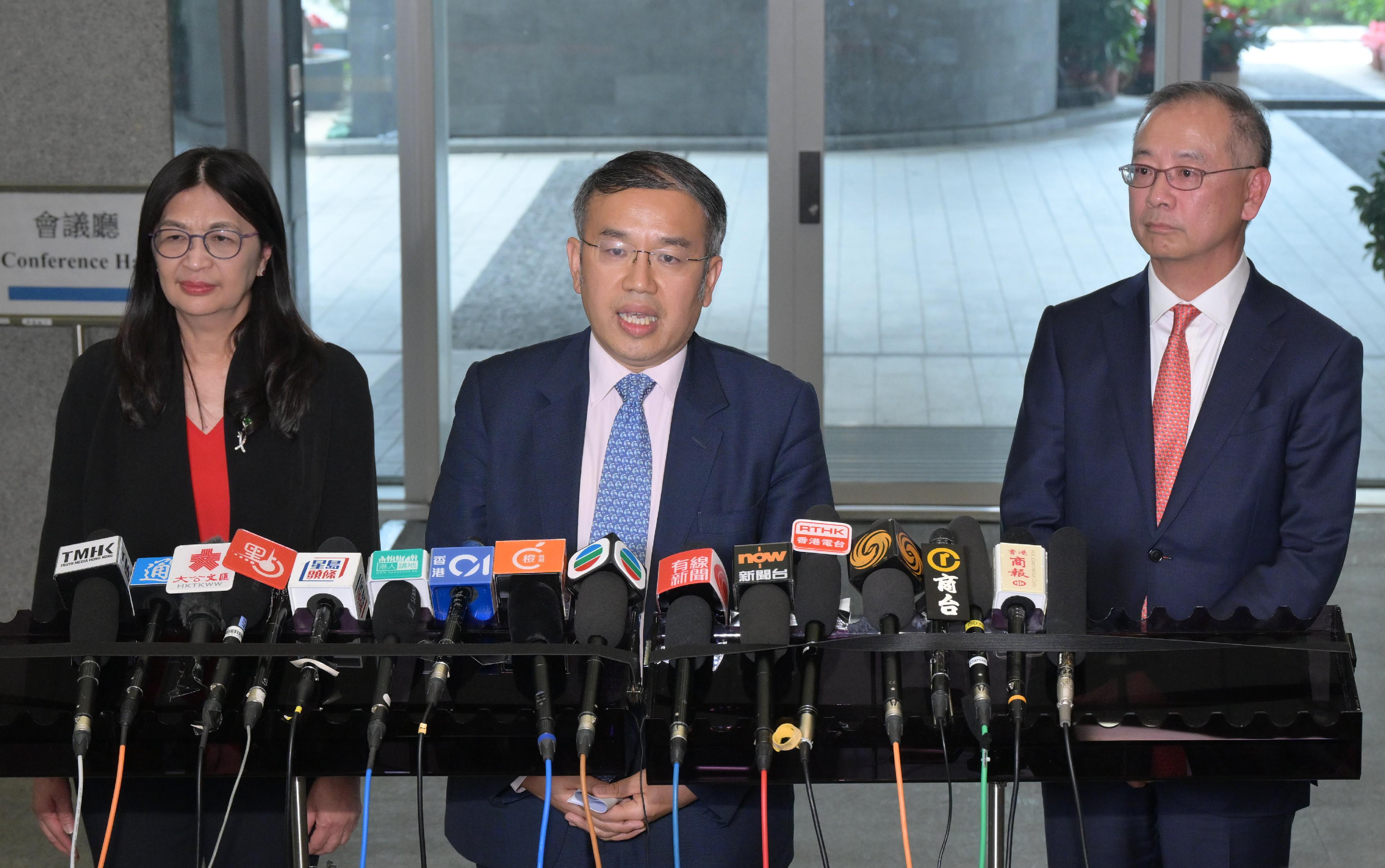 The Secretary for Financial Services and the Treasury, Mr Christopher Hui (centre); the Chief Executive of the Hong Kong Monetary Authority, Mr Eddie Yue (right); and the Chief Executive Officer of the Securities and Futures Commission, Ms Julia Leung (left), meet the media at the Central Government Offices today (February 26).
