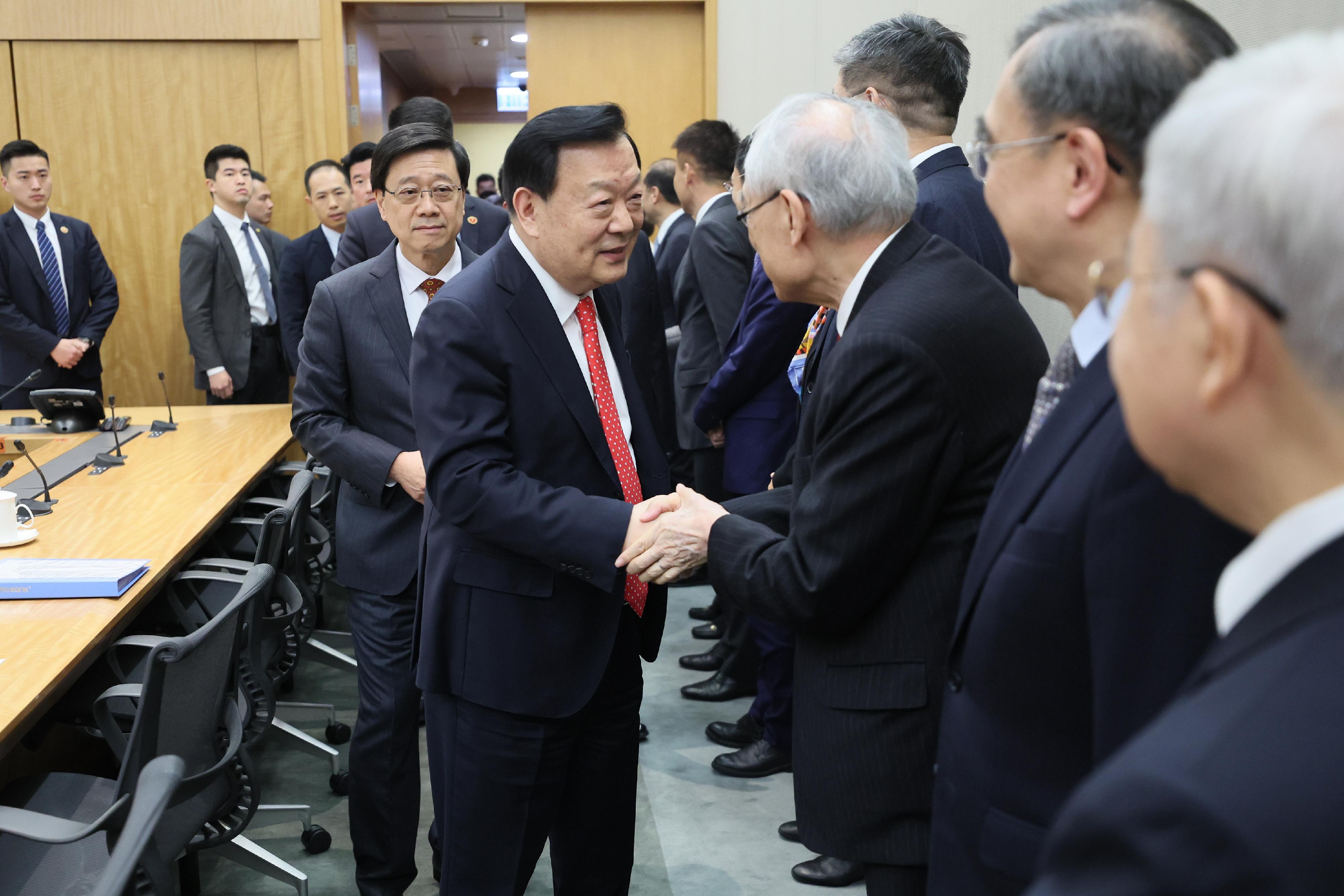 The Director of the Hong Kong and Macao Work Office of the Communist Party of China Central Committee and the Hong Kong and Macao Affairs Office of the State Council, Mr Xia Baolong, today (February 27) continued his inspection visit to Hong Kong. Photo shows Mr Xia (second left), accompanied by the Chief Executive, Mr John Lee (first left), having an exchange session with some economists to share views on economic development strategies of Hong Kong.