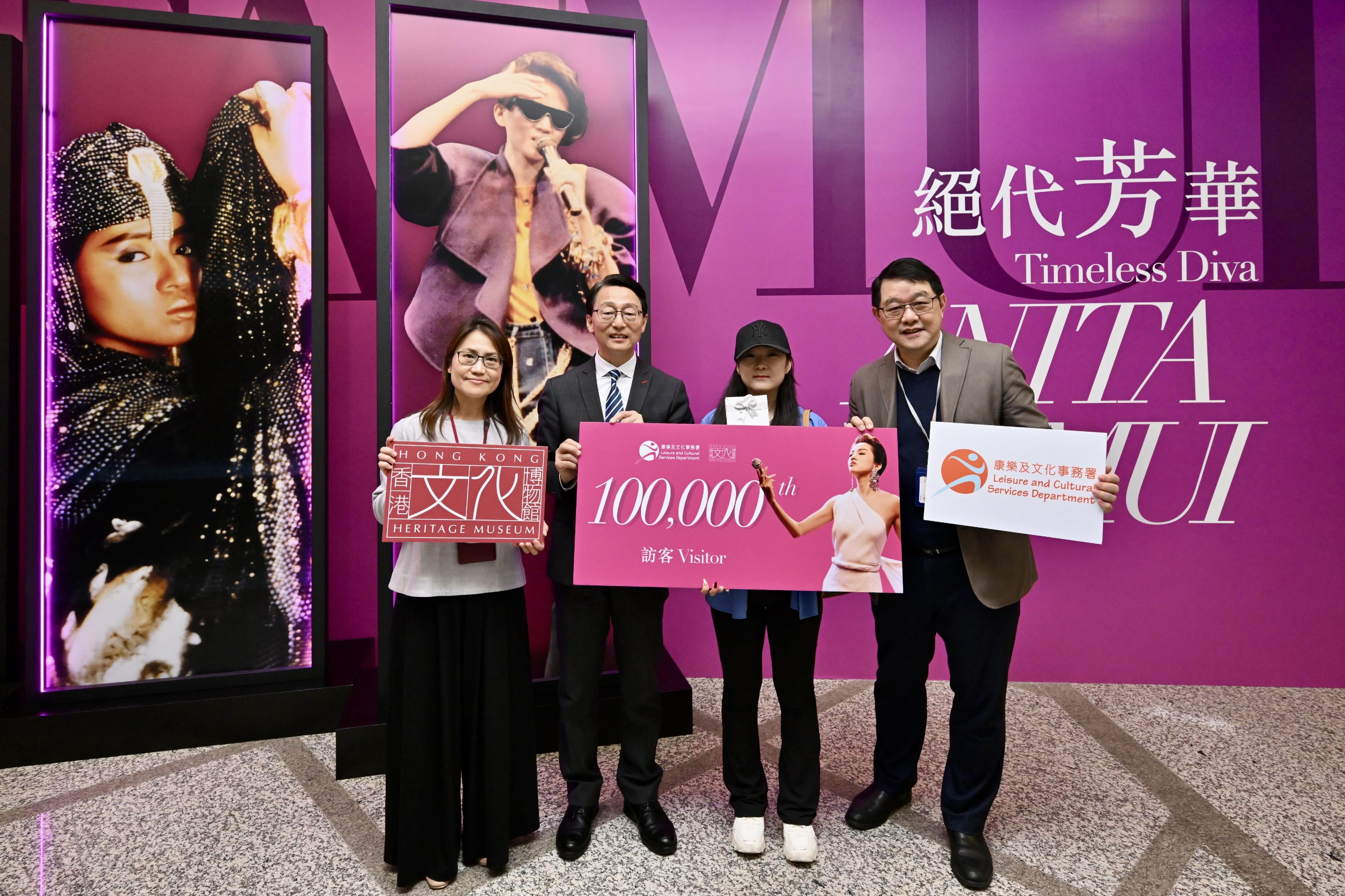 The ongoing exhibition at the Hong Kong Heritage Museum (HKHM) of the Leisure and Cultural Services Department, "Timeless Diva: Anita Mui", is highly acclaimed by the public and has reached 100 000 visitors from its opening on December 24 last year to yesterday (March 6). Picture shows the Director of Leisure and Cultural Services, Mr Vincent Liu (second left); the Museum Director of the HKHM, Mr Brian Lam (first right); and the Curator (History) of the HKHM, Ms Irene Chan (first left), welcoming the 100 000th visitor of the exhibition and presenting a gift pack to the visitor.