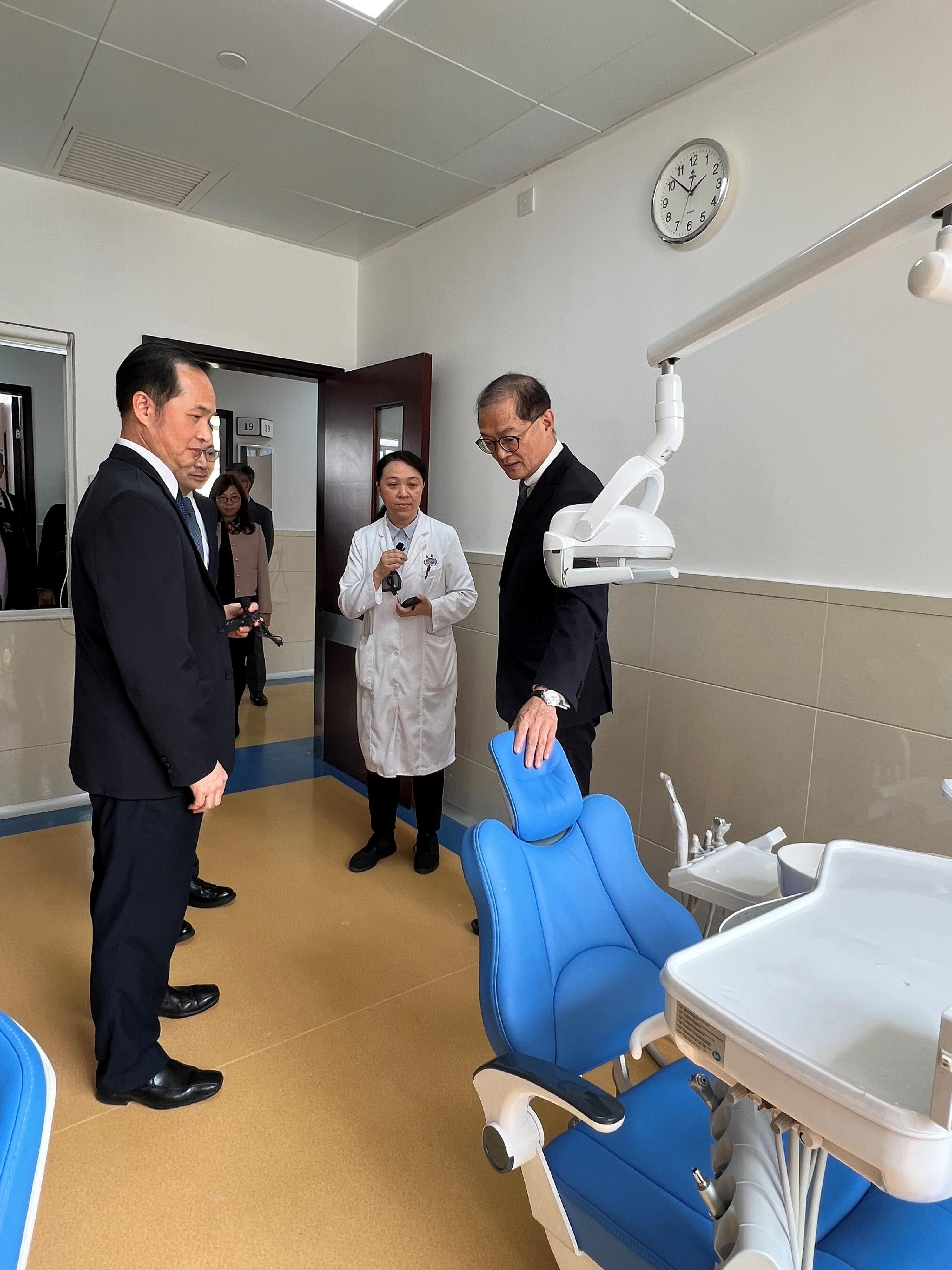 The Secretary for Health, Professor Lo Chung-mau, and his delegation visited the Dongguan Tungwah Hospital in Dongguan today (March 14). Photo shows Professor Lo (first right) visiting the Department of Stomatology of the hospital.