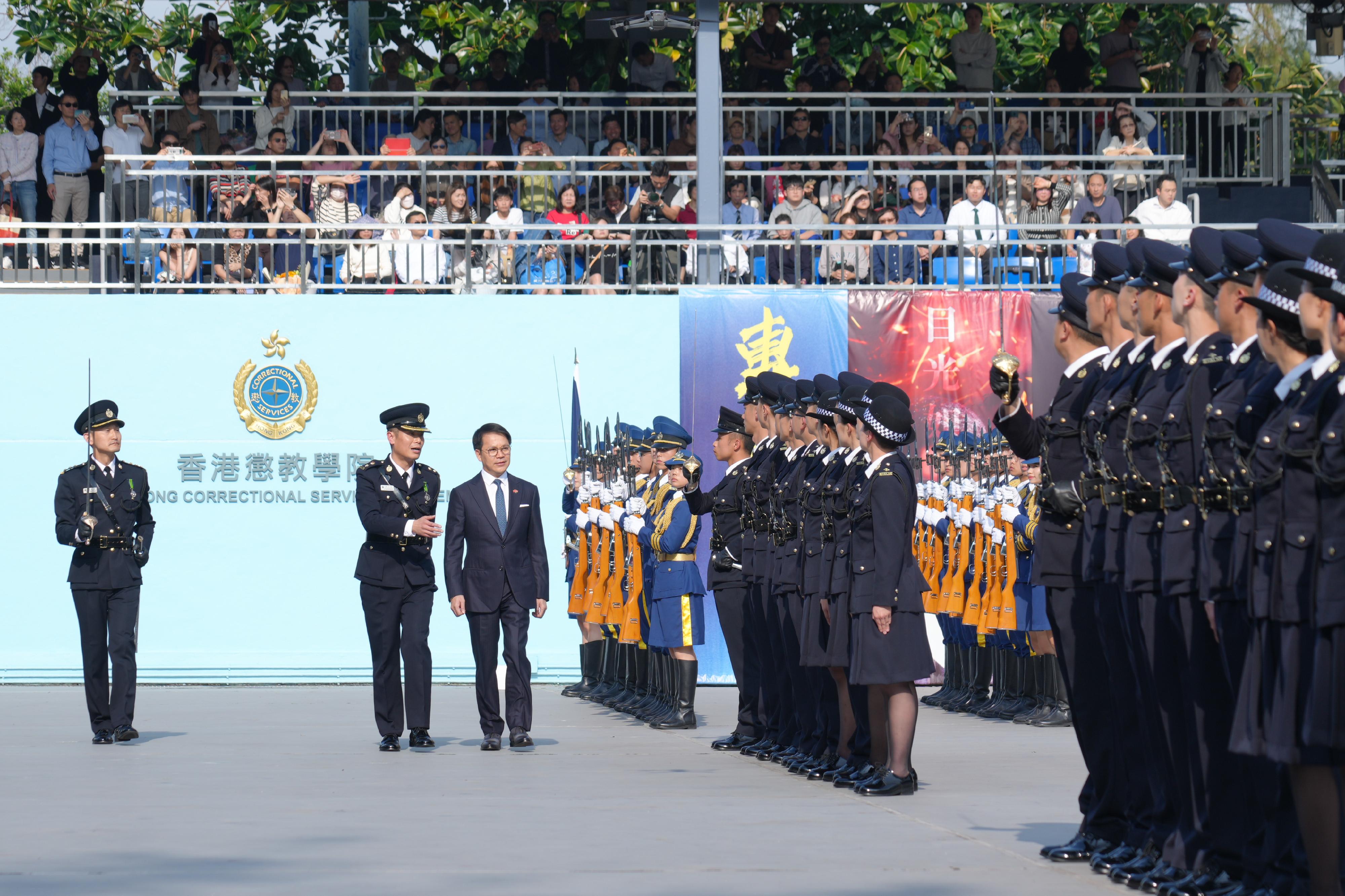 The Correctional Services Department held a passing-out parade at the Hong Kong Correctional Services Academy today (March 22). Photo shows the Chairman of the Legislative Council Panel on Security, Mr Chan Hak-kan (centre), inspecting a contingent of graduates.