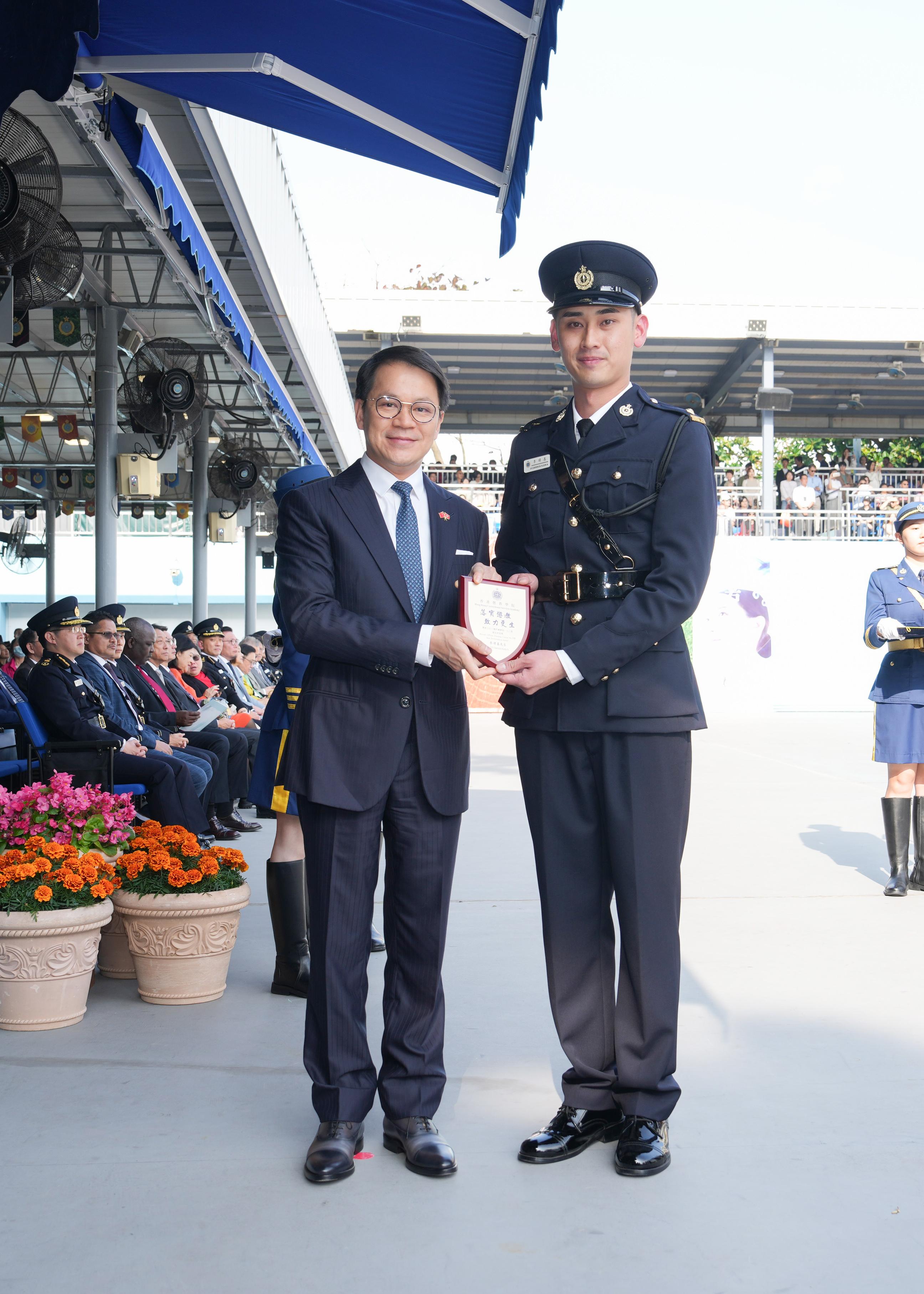 The Chairman of the Legislative Council Panel on Security, Mr Chan Hak-kan, attended the Correctional Services Department passing-out parade today (March 22). Photo shows Mr Chan (left) presenting a Best Recruit Award, the Principal's Shield, to Officer Mr Dy Derrick Klein A.