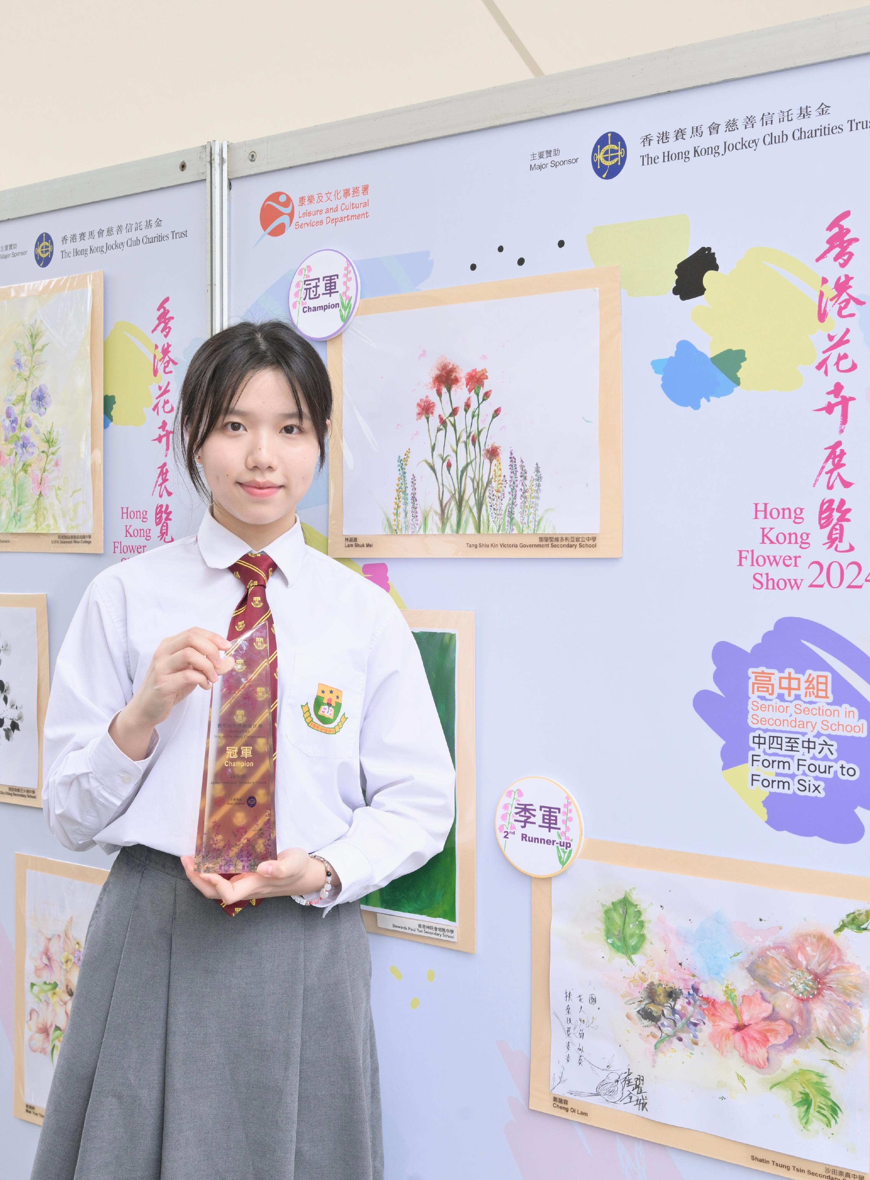 The Hong Kong Flower Show at Victoria Park will close at 9pm tomorrow (March 24). During the show period, various recreational fringe activities have been held, among which the Jockey Club Student Drawing Competition held its prize presentation ceremony today (March 23). Winning entries are now on display at the showground. Photo shows the champion of the Senior Section in Secondary School, Lam Shuk-mei, and her work.
