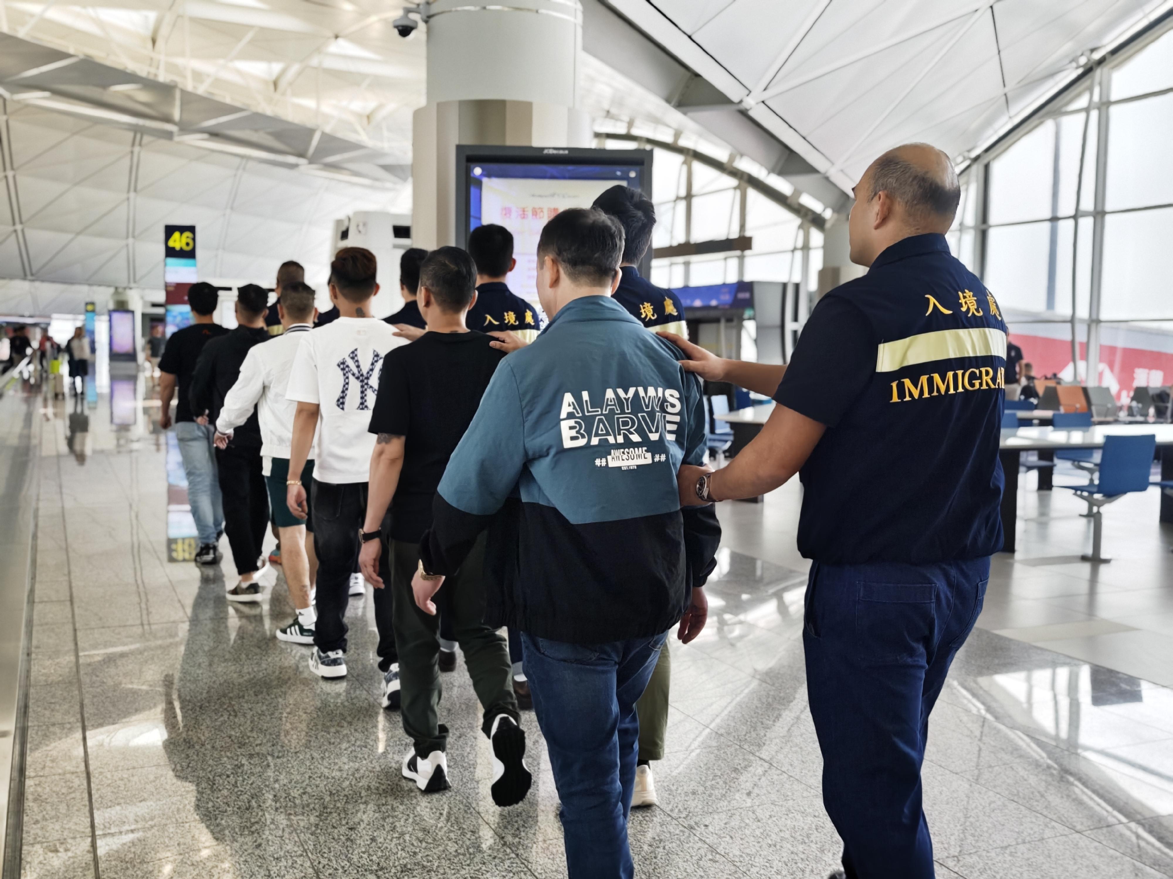 The Immigration Department (ImmD) carried out a repatriation operation today (March 26). A total of 27 Vietnamese illegal immigrants were repatriated to Vietnam. Photo shows the illegal immigrants being escorted by ImmD officers to depart from Hong Kong.