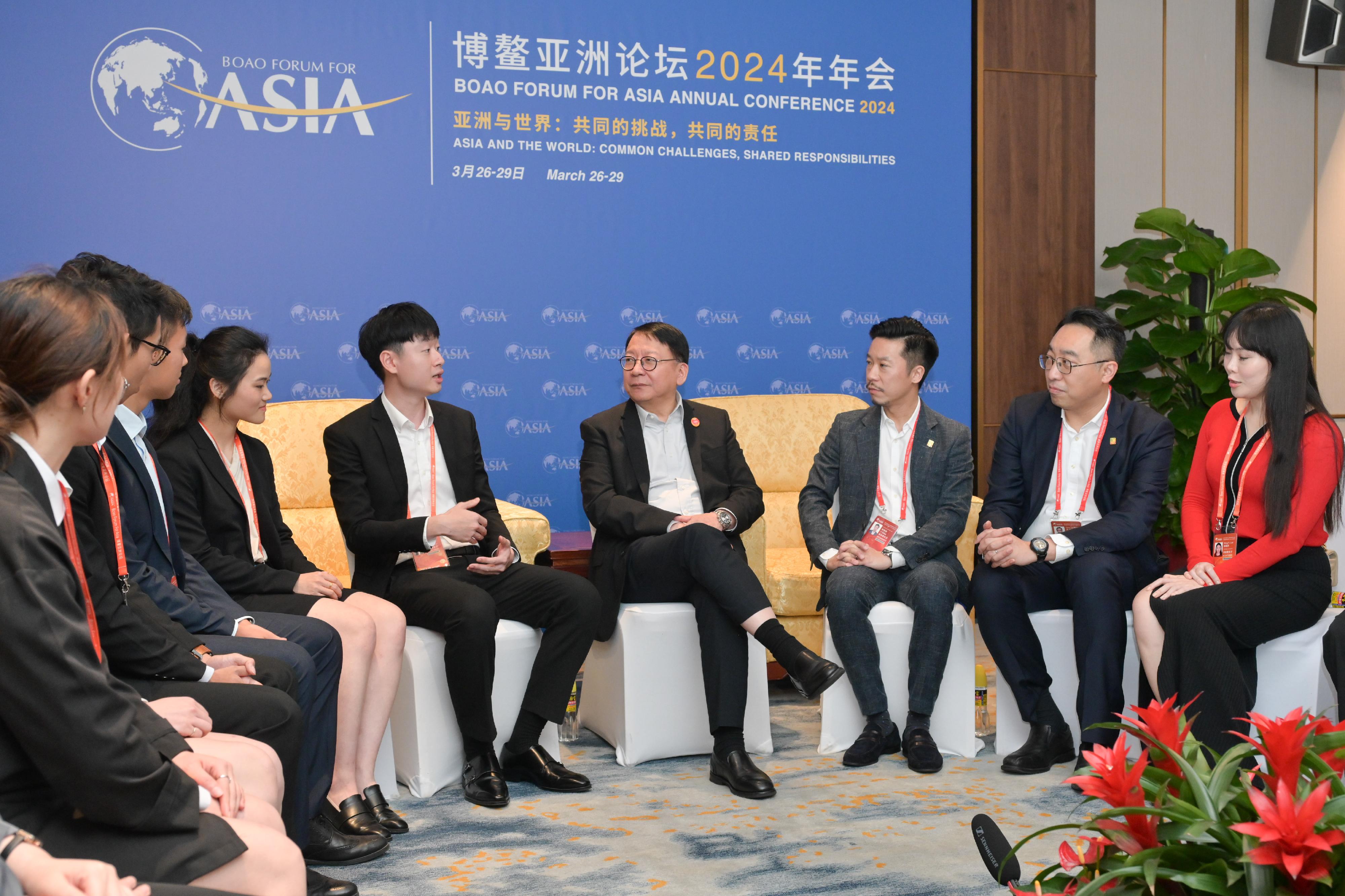 The Chief Secretary for Administration, Mr Chan Kwok-ki, met with the Hong Kong youth serving as volunteers at the Boao Forum for Asia Annual Conference 2024 in Hainan today (March 27). Photo shows Mr Chan (fourth right) interacting with the Chairman of the Y. Elites Association, Mr Lawrence Lam (third right); the Executive Deputy Chairman of the Y. Elites Association, Mr Jason Wong (second right) and the Hong Kong youth volunteers, to understand their work and views.