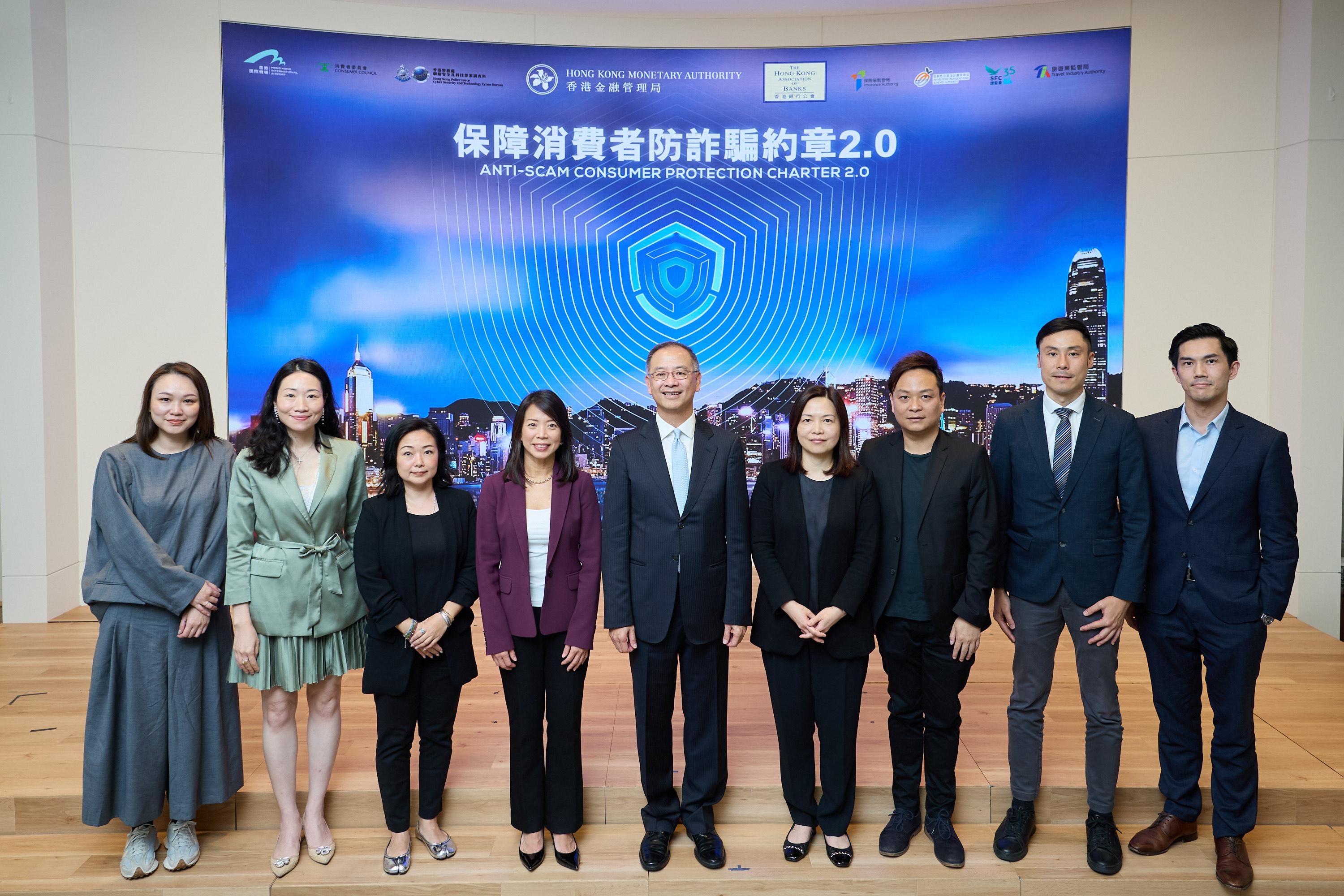 The Chief Executive of the Hong Kong Monetary Authority, Mr Eddie Yue (fifth left); the Chairman of the Hong Kong Association of Banks and the Chief Executive Officer, Hong Kong, HSBC, Ms Luanne Lim (fourth left); and representatives of merchant institutions attended the event to support the Anti-Scam Consumer Protection Charter 2.0.