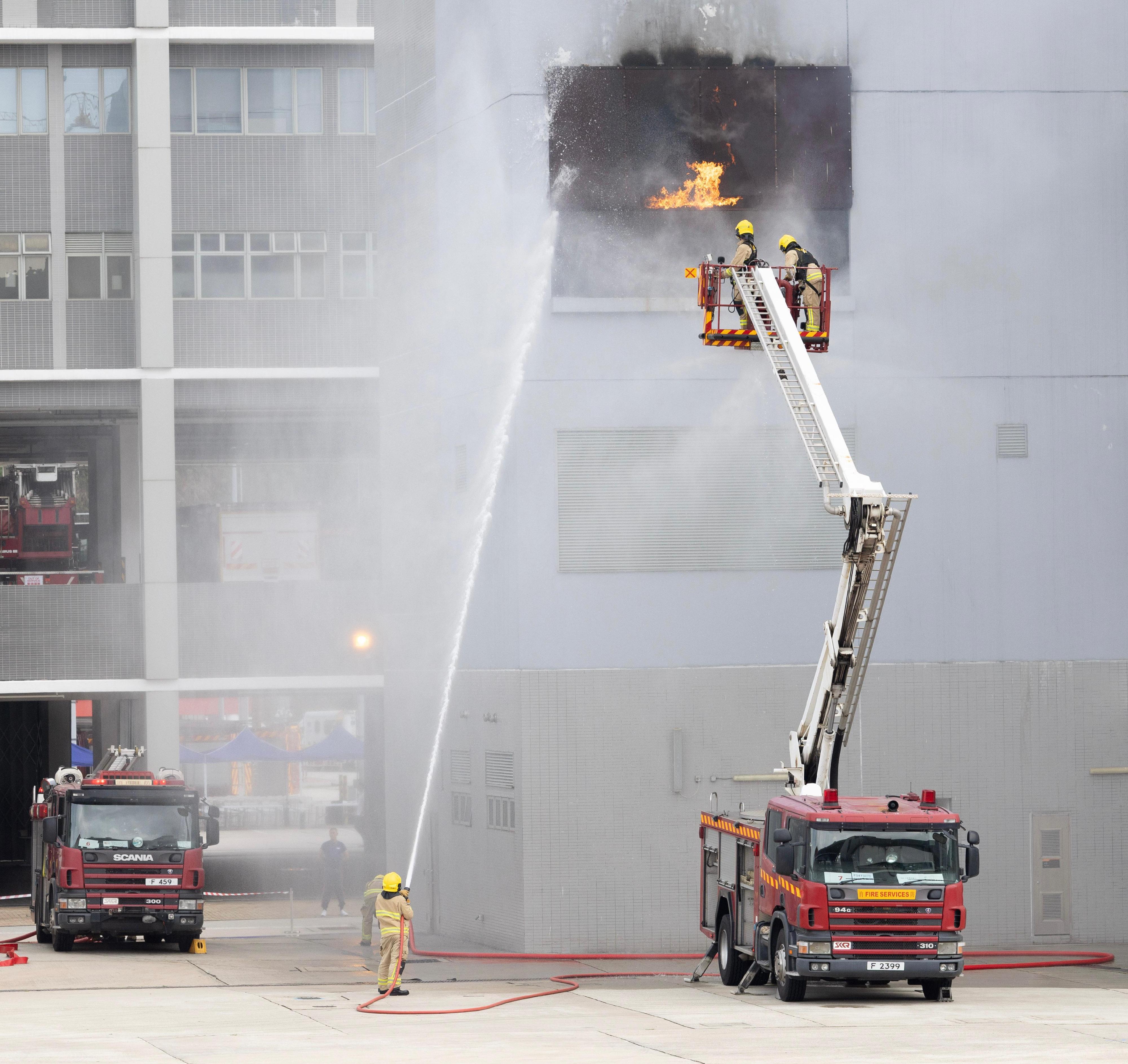 In response to and support of National Security Education Day, the Fire Services Department (FSD) held an open day at the Fire and Ambulance Services Academy in Tseung Kwan O today (April 14). Photo shows FSD personnel performing firefighting demonstration.