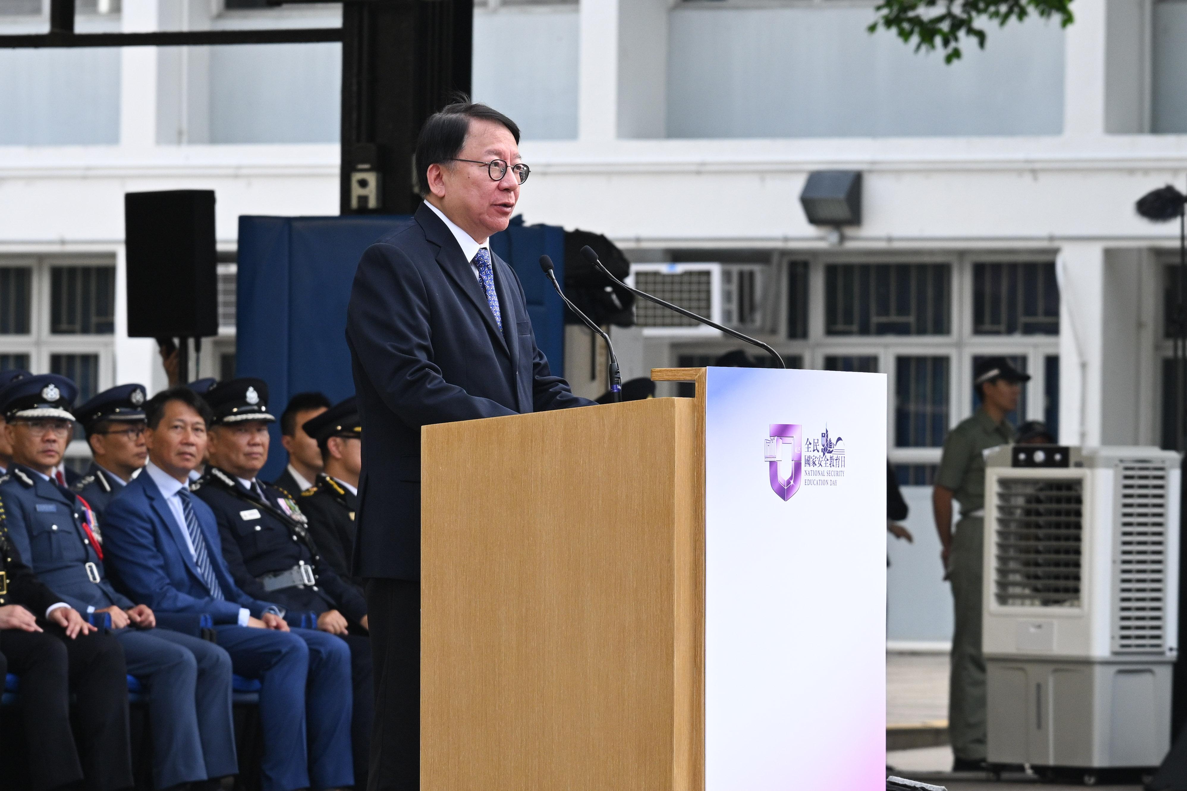 The Chief Secretary for Administration, Mr Chan Kwok-ki, speaks at the National Security Education Day flag raising ceremony today (April 15).