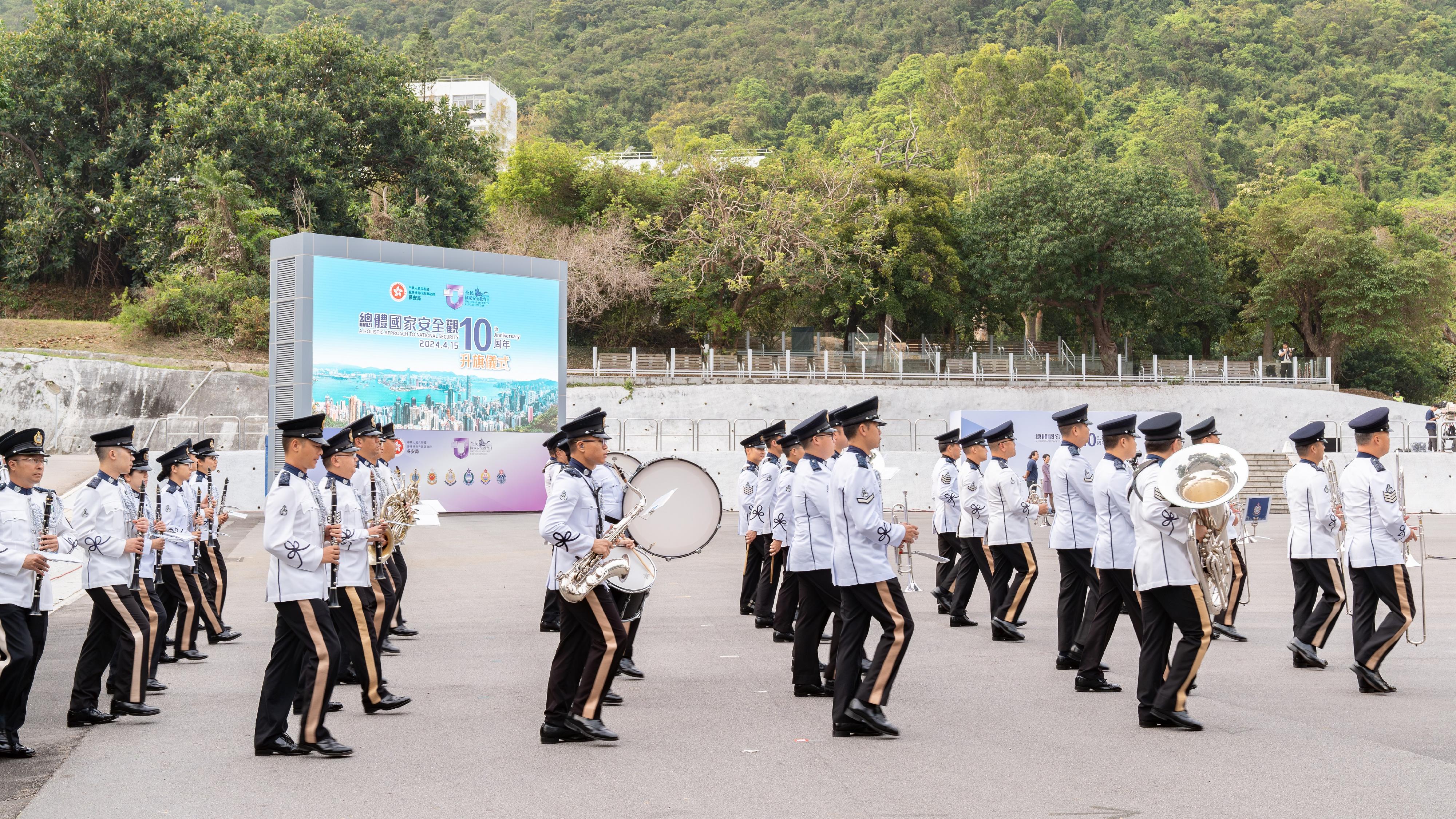 The Security Bureau and its disciplined services jointly held a National Security Education Day flag-raising ceremony at the Hong Kong Police College today (April 15). Photo shows the Hong Kong Police Band conducting a performance to open the ceremony.