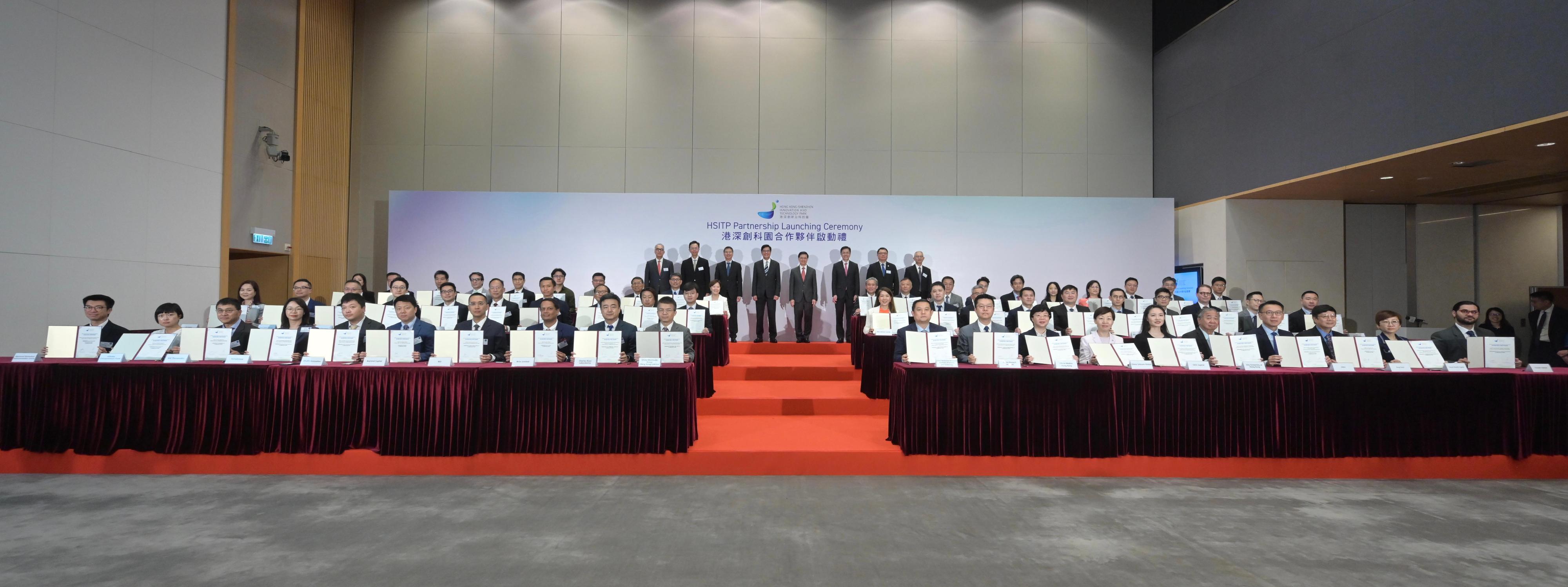 The Chief Executive, Mr John Lee, attended the Hong Kong-Shenzhen Innovation and Technology Park Partnership Launching Ceremony today (April 18). Photo shows (fourth row, from second left) the Alternate Chairperson of the Hong Kong-Shenzhen Innovation and Technology Park Limited, Professor John Chai; the Permanent Secretary for Innovation, Technology and Industry, Mr Eddie Mak; the Acting Financial Secretary, Mr Michael Wong; Mr Lee; the Secretary for Innovation, Technology and Industry, Professor Sun Dong; the Chairman of the Hong Kong Science and Technology Parks Corporation, Dr Sunny Chai, and other guests witnessing the signing of Memoranda of Understanding between the Hong Kong-Shenzhen Innovation and Technology Park Limited and representatives of enterprises at the ceremony.

