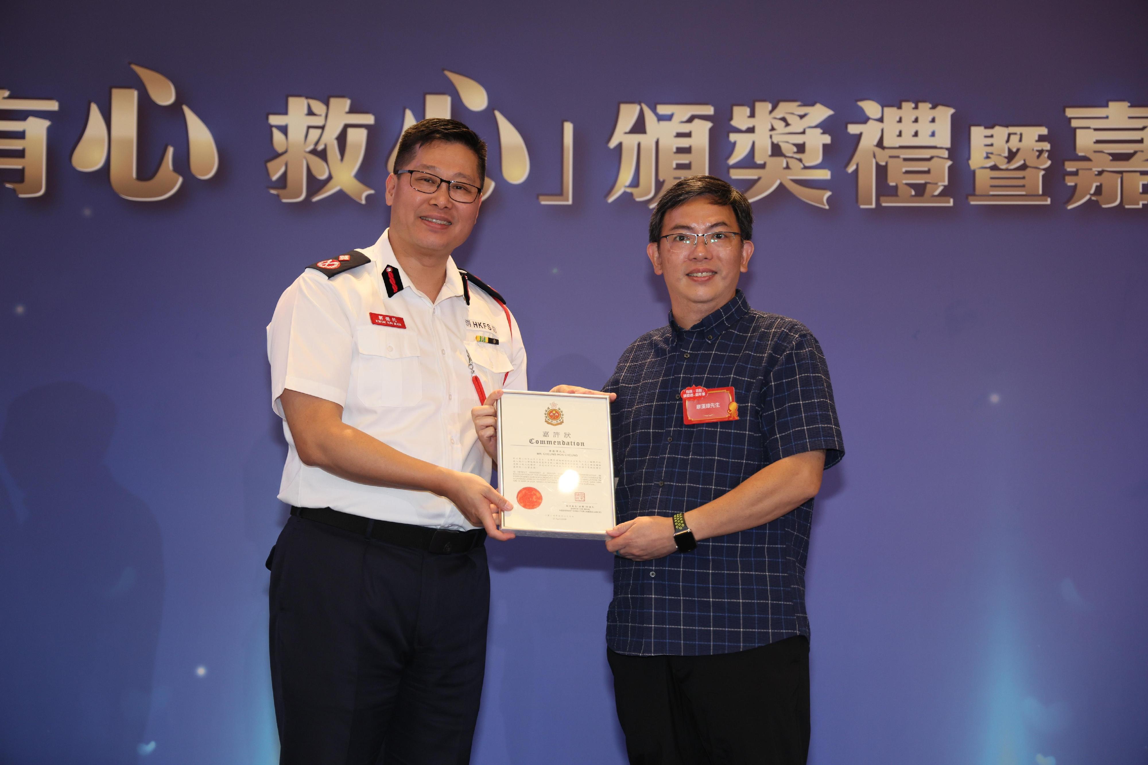 消防處助理處長（救護）郭健民（左）頒發「『救心仁』獎」予得獎者。