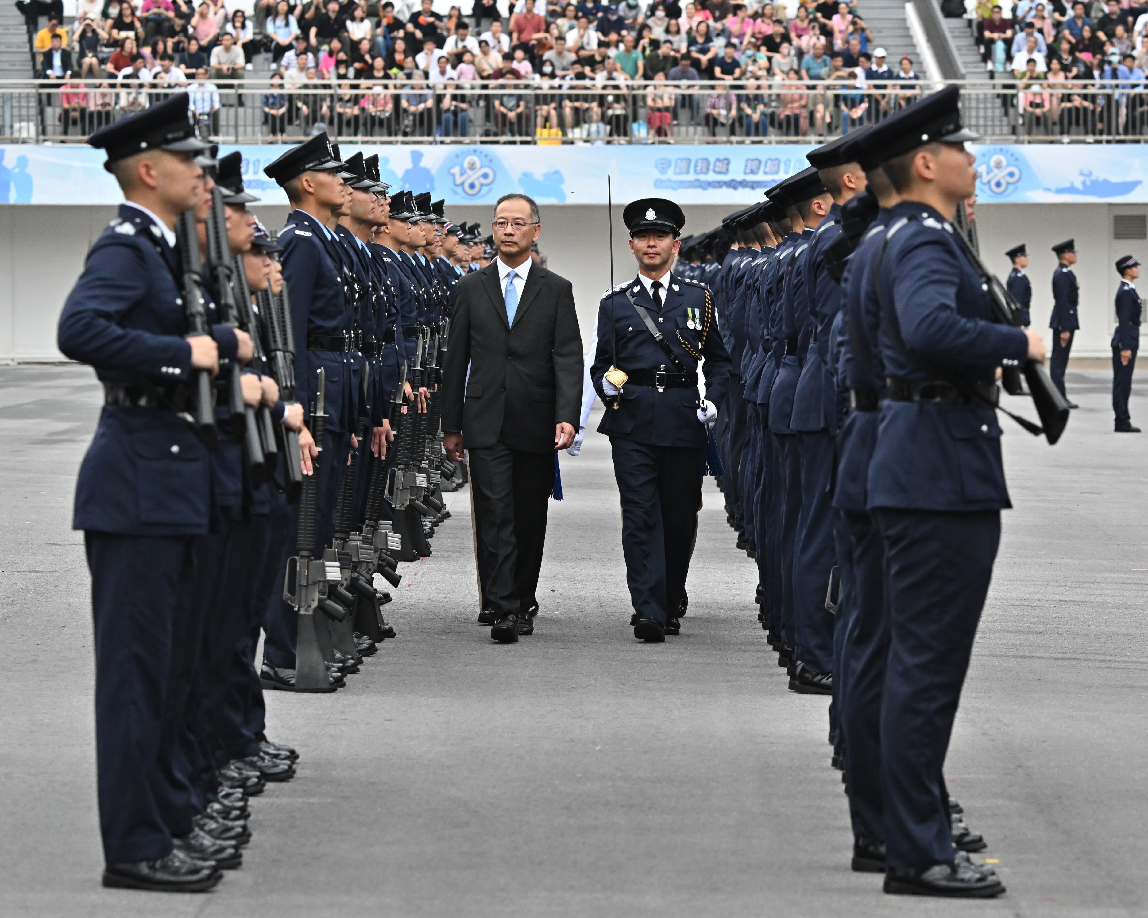 The Chief Executive of the Hong Kong Monetary Authority, Mr Eddie Yue Wai-man, inspects a passing-out parade as a reviewing officer at the Hong Kong Police College today (April 27).