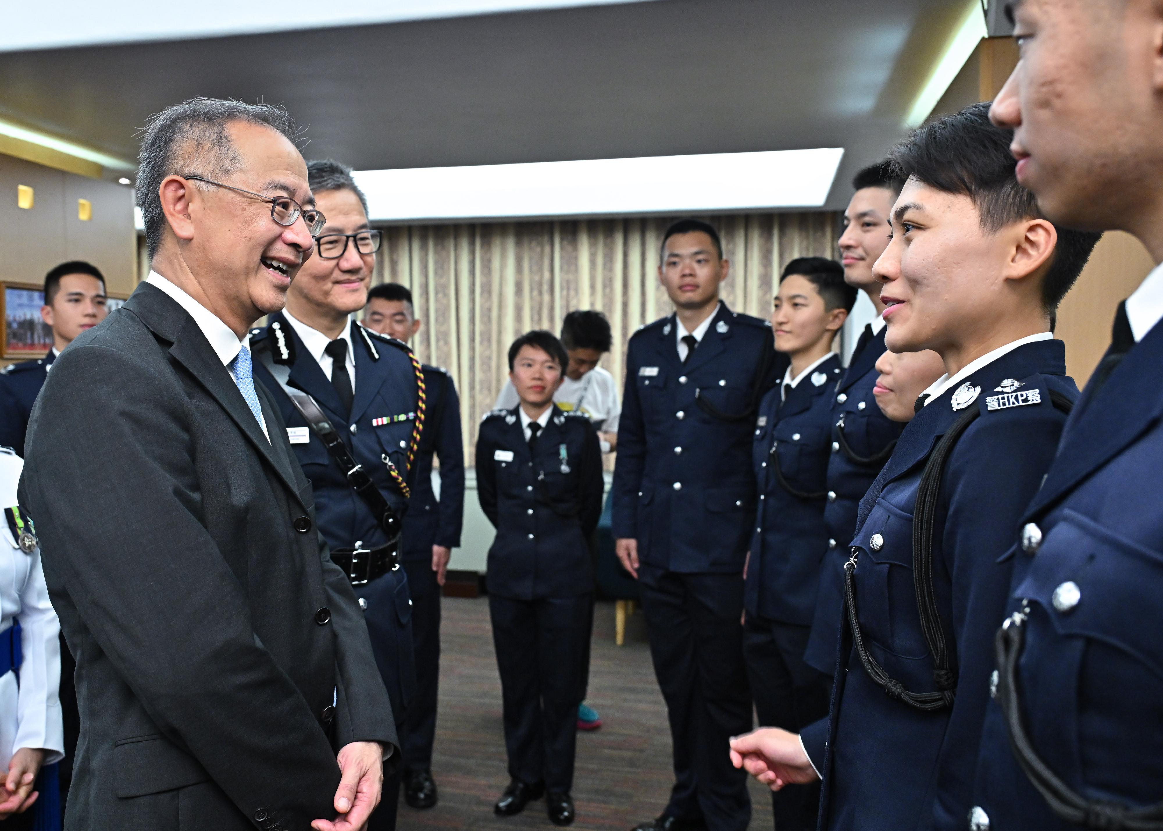 The Chief Executive of the Hong Kong Monetary Authority, Mr Eddie Yue Wai-man (first left), and the Commissioner of Police, Mr Siu Chak-yee (second left) congratulate the probationary inspectors after the passing-out parade held at the Hong Kong Police College today (April 27).