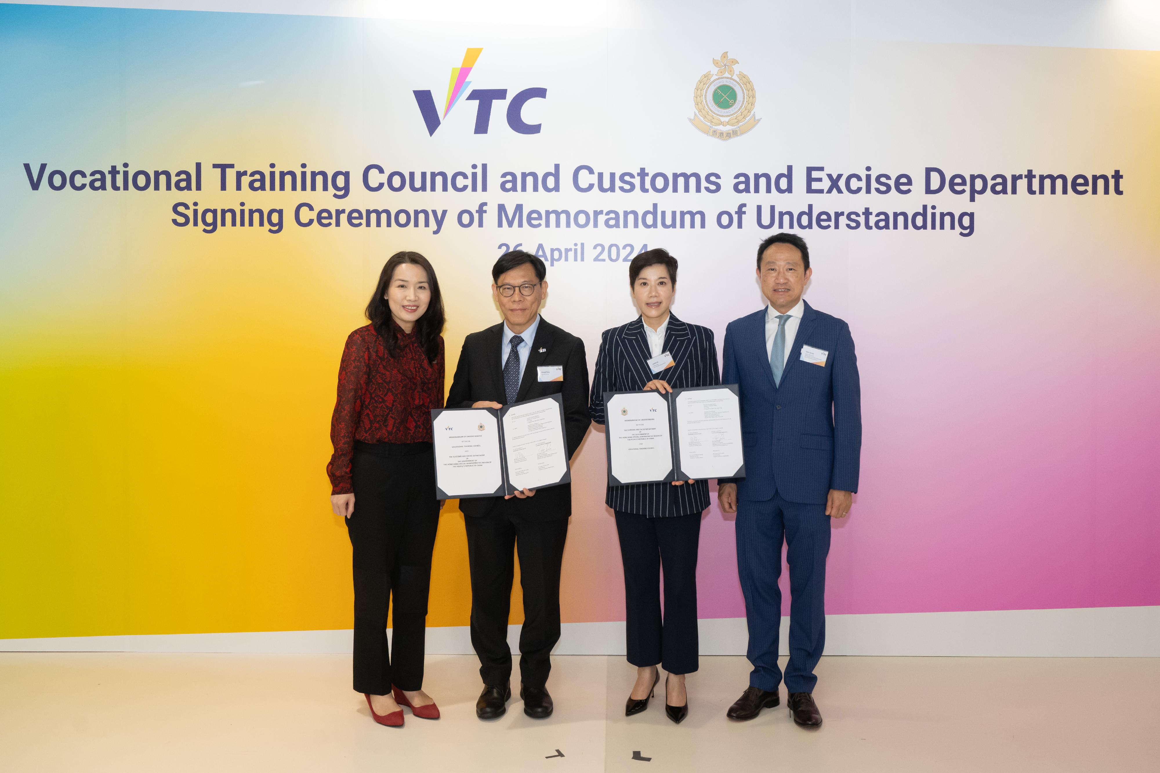 The Customs and Excise Department signed a Memorandum of Understanding with the Vocational Training Council (VTC) on April 26 for enhancing Customs officers' training in professional areas and promoting Customs work and "Customs YES" to VTC students. Photo shows (from left) Deputy Executive Director of the VTC Ms Alaina Shum; the Executive Director of the VTC, Mr Donald Tong; the Commissioner of Customs and Excise, Ms Louise Ho; and  the Deputy Commissioner (Management and Strategic Development) of Customs, Mr Chan Tsz-tat, at the signing ceremony.