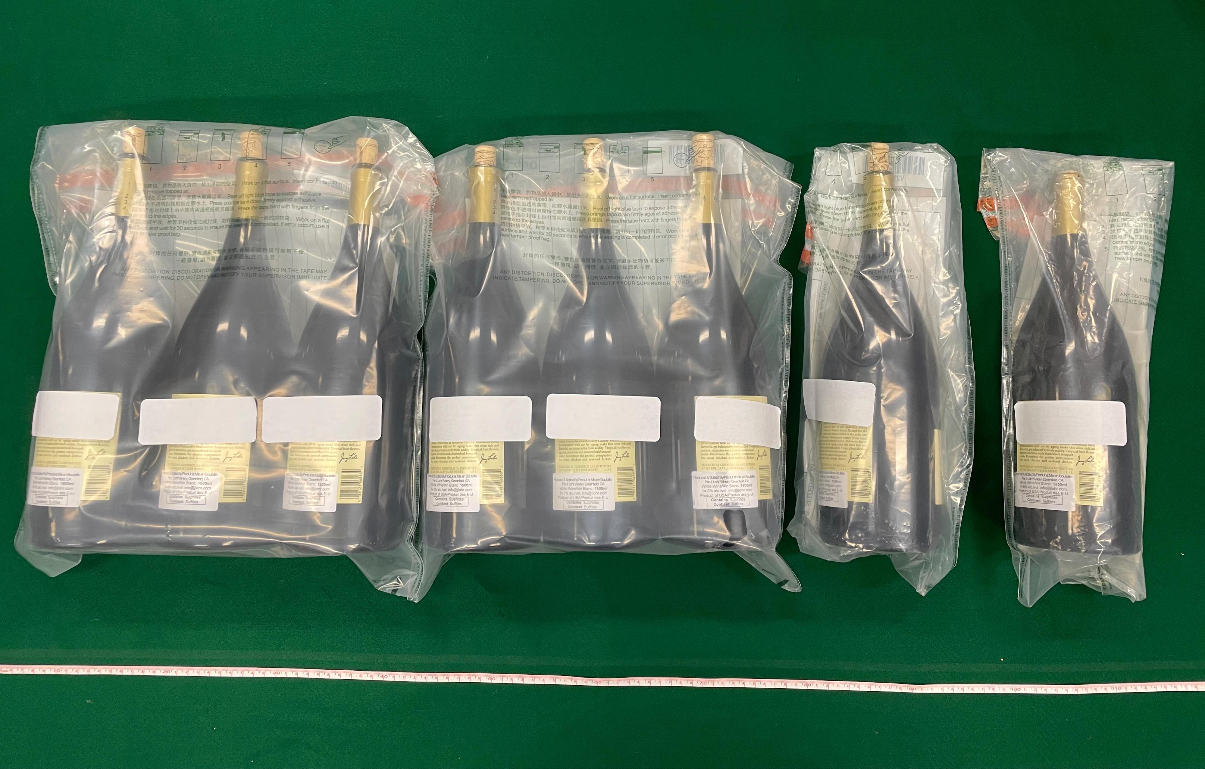 Hong Kong Customs yesterday (April 28) conducted an anti-narcotics operation in Tsim Sha Tsui and seized a total of about 12 kilograms of suspected liquid cocaine with a total estimated market value of about $12 million. Photo shows the wine bottles in which the suspected dangerous drugs seized were found.