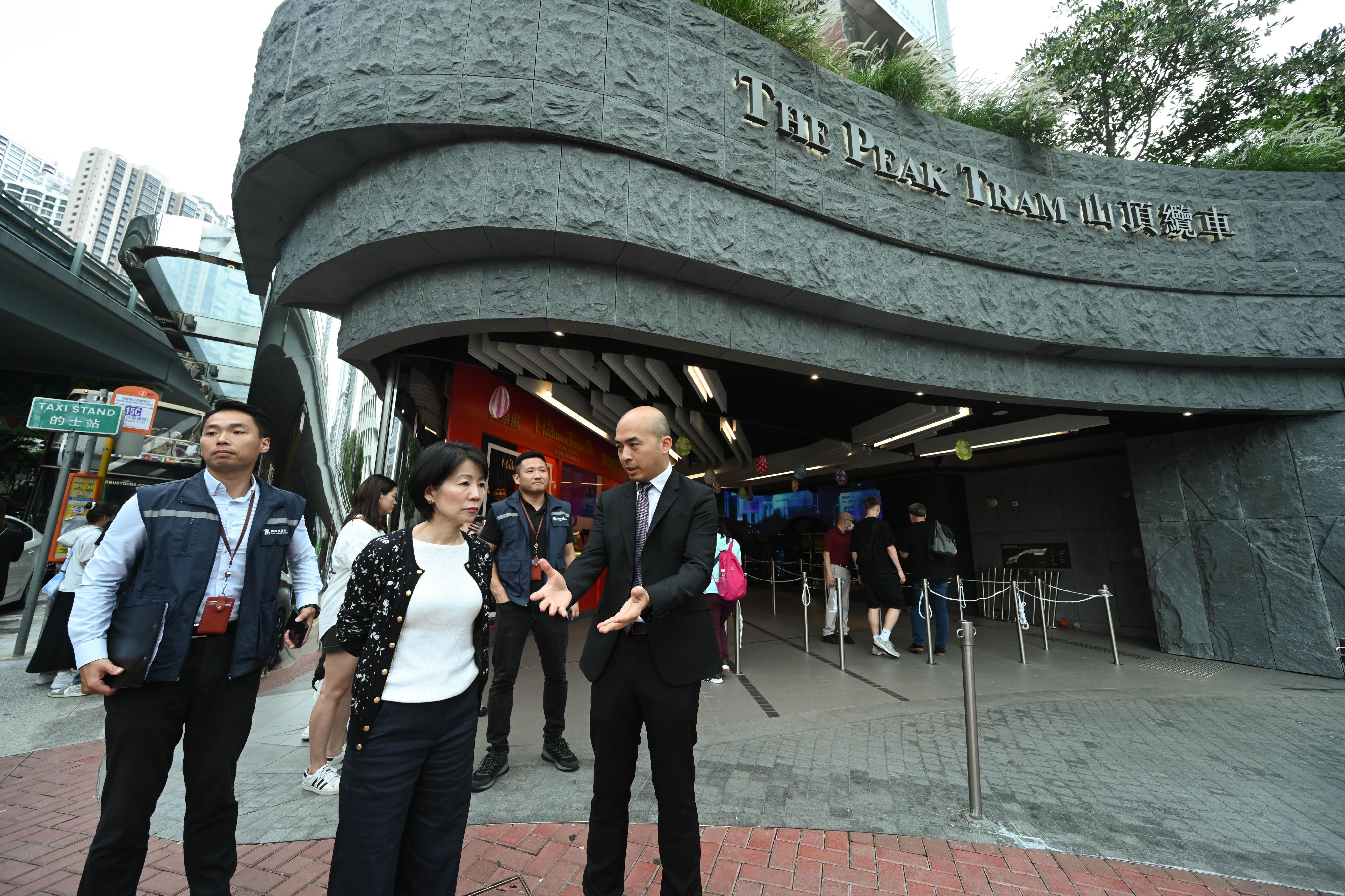 The Commissioner for Tourism, Ms Vivian Sum (centre), today (April 29) visited the Garden Road Peak Tram Station with representatives of the Travel Industry Authority to monitor the crowd management arrangements of the tourist attraction during the 2024 Labour Day Golden Week of the Mainland.