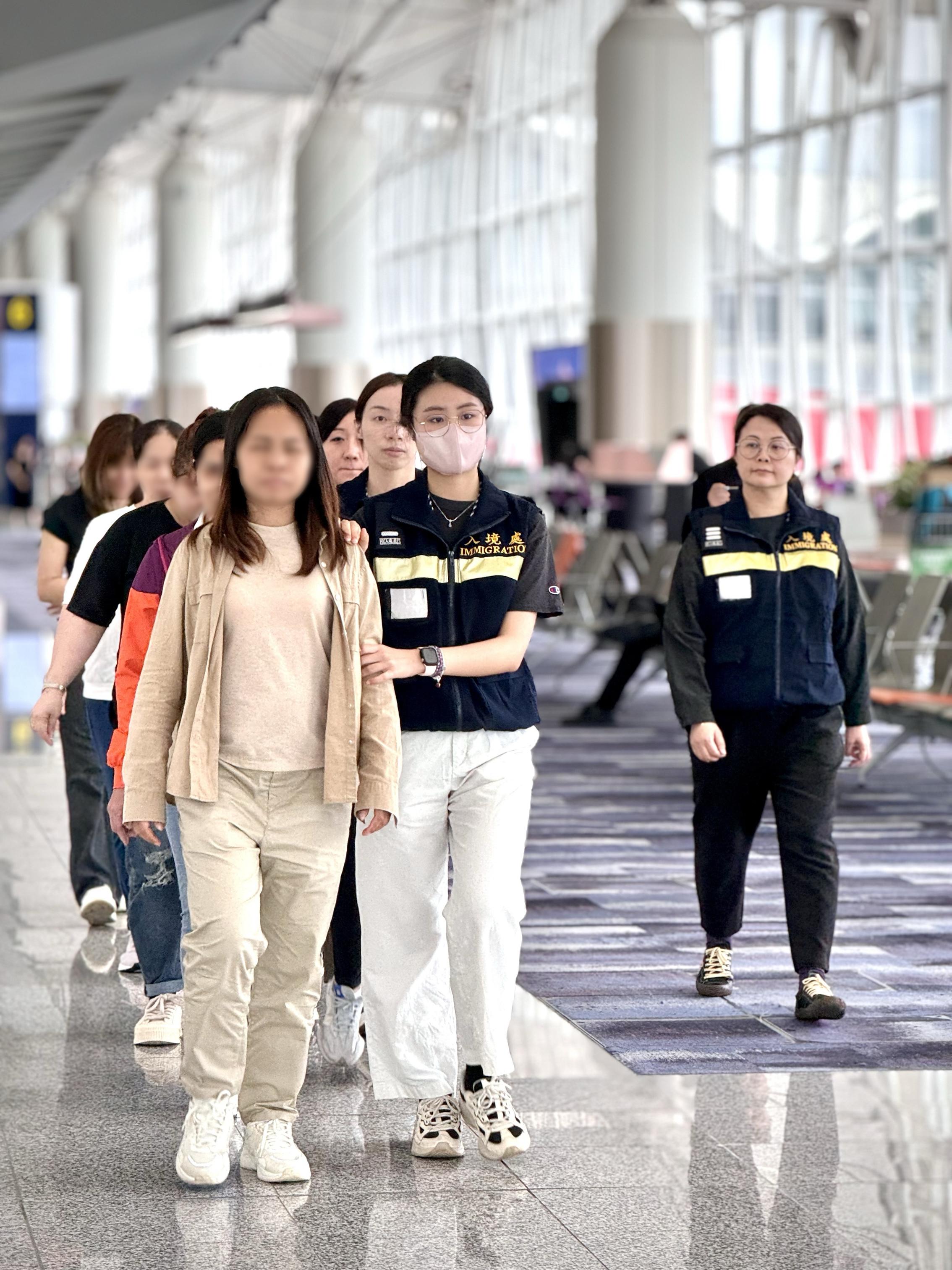 The Immigration Department (ImmD) carried out a repatriation operation today (April 30). A total of 26 Vietnamese illegal immigrants were repatriated to Vietnam. Photo shows removees being escorted by ImmD officers to depart from Hong Kong.