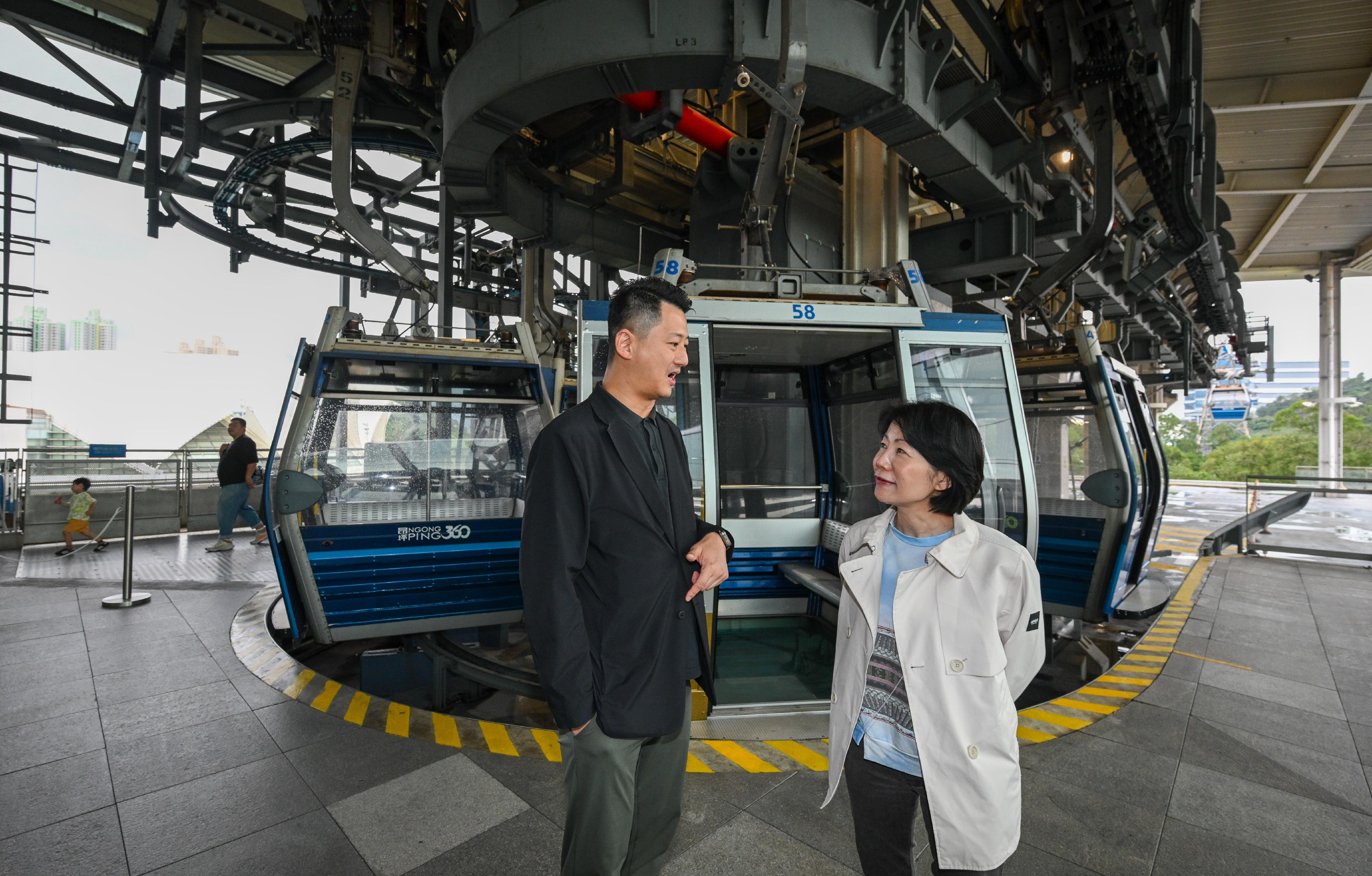 The Commissioner for Tourism, Ms Vivian Sum (right), today (May 1) visited Ngong Ping 360 to monitor crowd management and tourist activities of the tourist attraction during the 2024 Labour Day Golden Week of the Mainland.