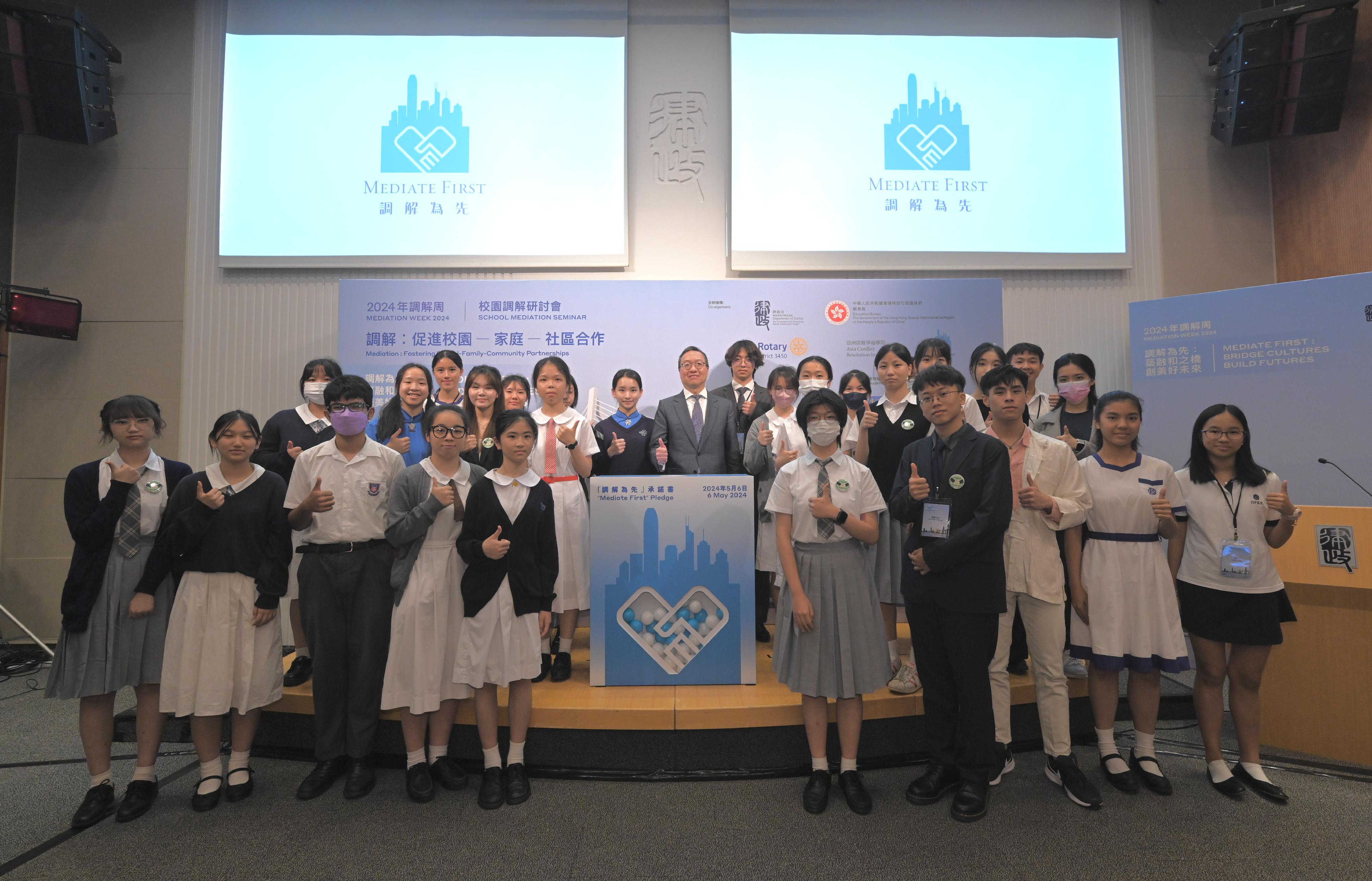 The Mediation Week 2024, a biennial event organised by the Department of Justice, was officially launched today (May 6). The Mediation Week opening was marked by the thematic event: School Mediation Seminar this morning. Photo shows the Secretary for Justice, Mr Paul Lam, SC (centre), and student pledgees at the "Mediate First" Pledge Signing Ceremony.
