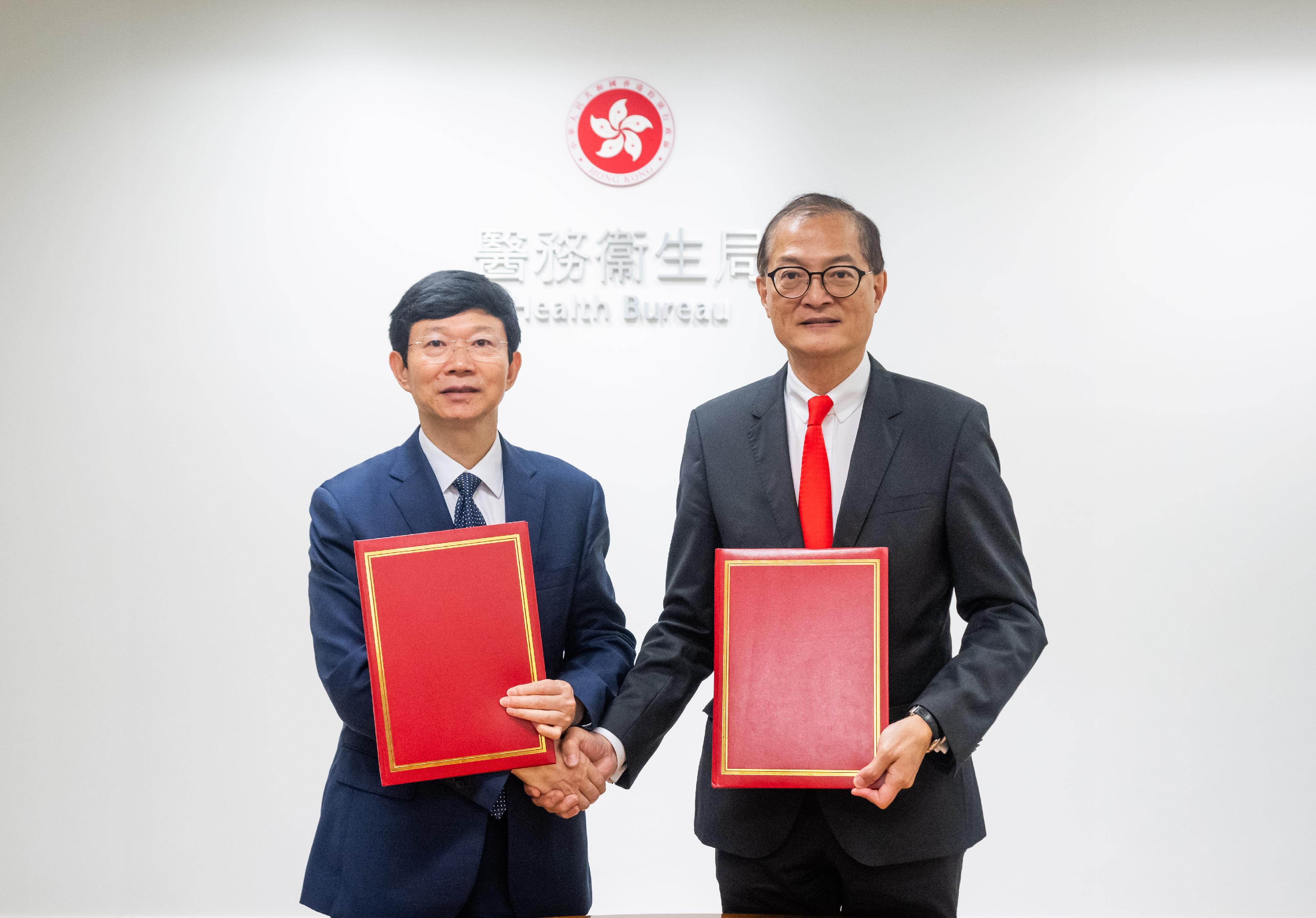 The Secretary for Health, Professor Lo Chung-mau (right), and the Commissioner of the National Medical Products Administration, Mr Li Li (left), renew the Co-operation Agreement on Regulation of Drugs and the Co-operation Agreement on Construction, Research and Management of Chinese Medicines Herbarium today (May 8).