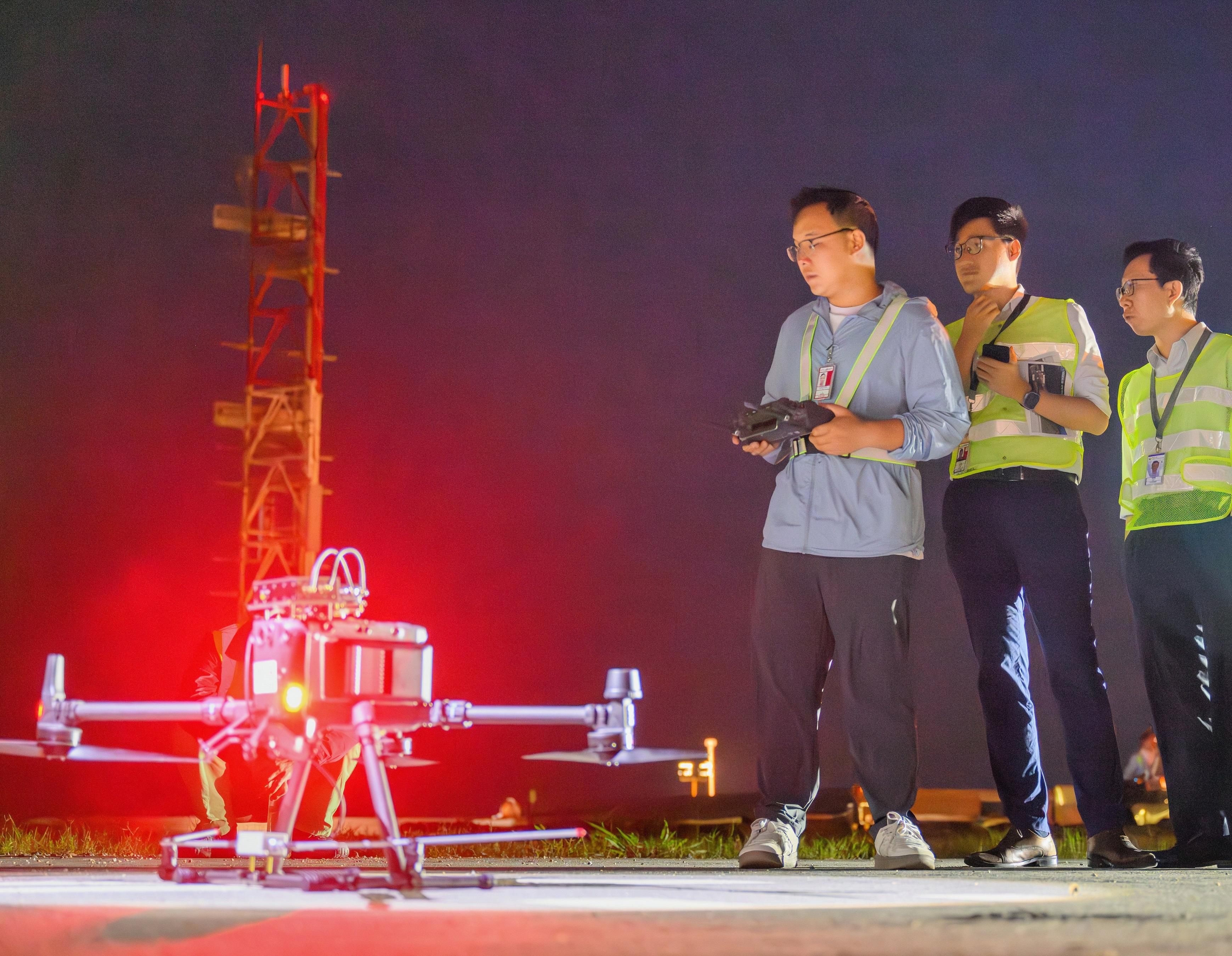 The Civil Aviation Department (CAD) conducted the second phase of a trial flight inspection by small unmanned aircraft at Hong Kong International Airport on May 9 and 10. Photo shows experts from the CAD and the Civil Aviation Administration of the China Flight Inspection Center preparing for the trial.