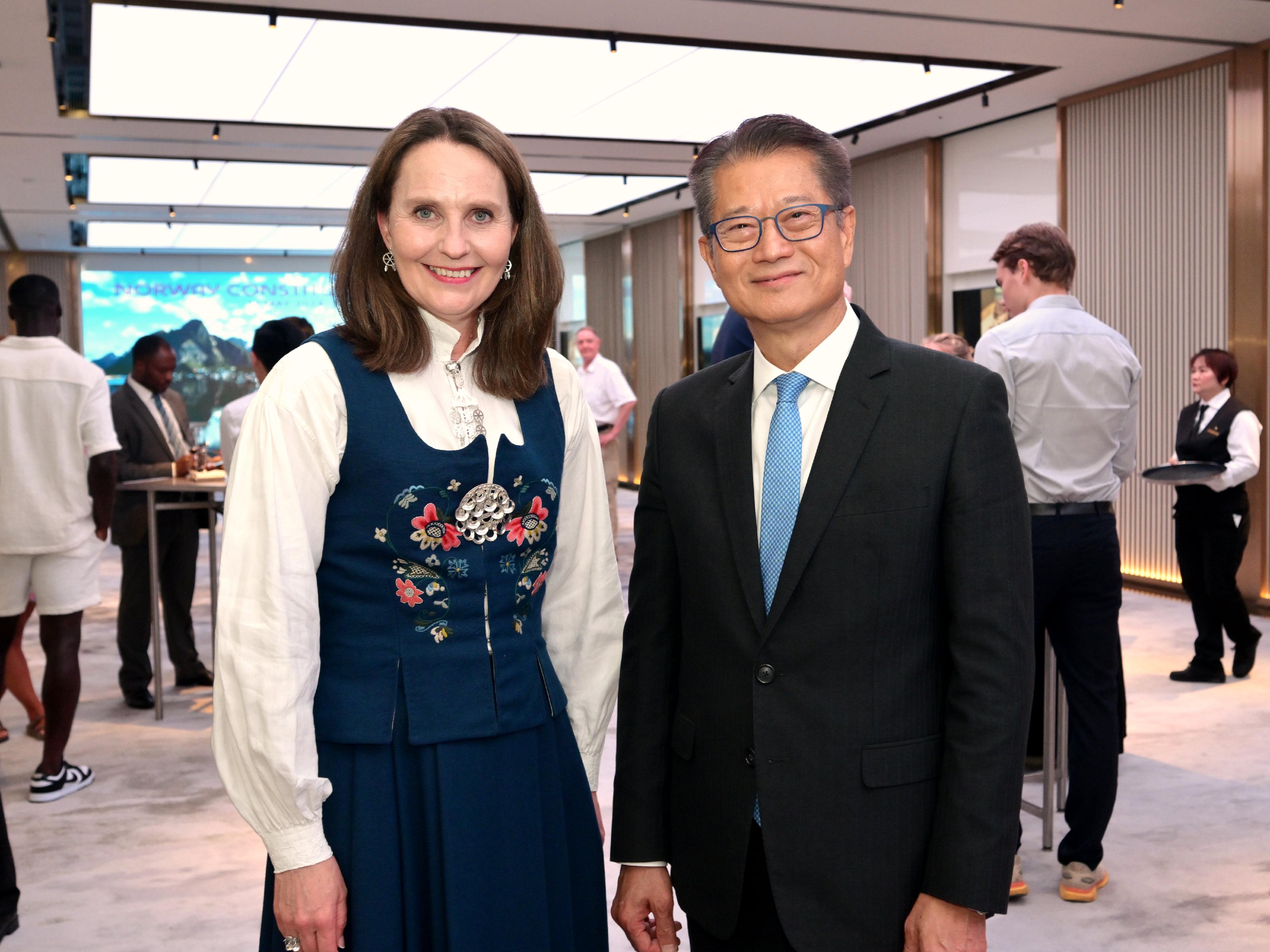 The Financial Secretary, Mr Paul Chan, attended the cocktail reception of the Constitution Day of Norway today (May 17). Photo shows Mr Chan (right) with the Norwegian Ambassador to China, Ms Signe Brudeset (left).