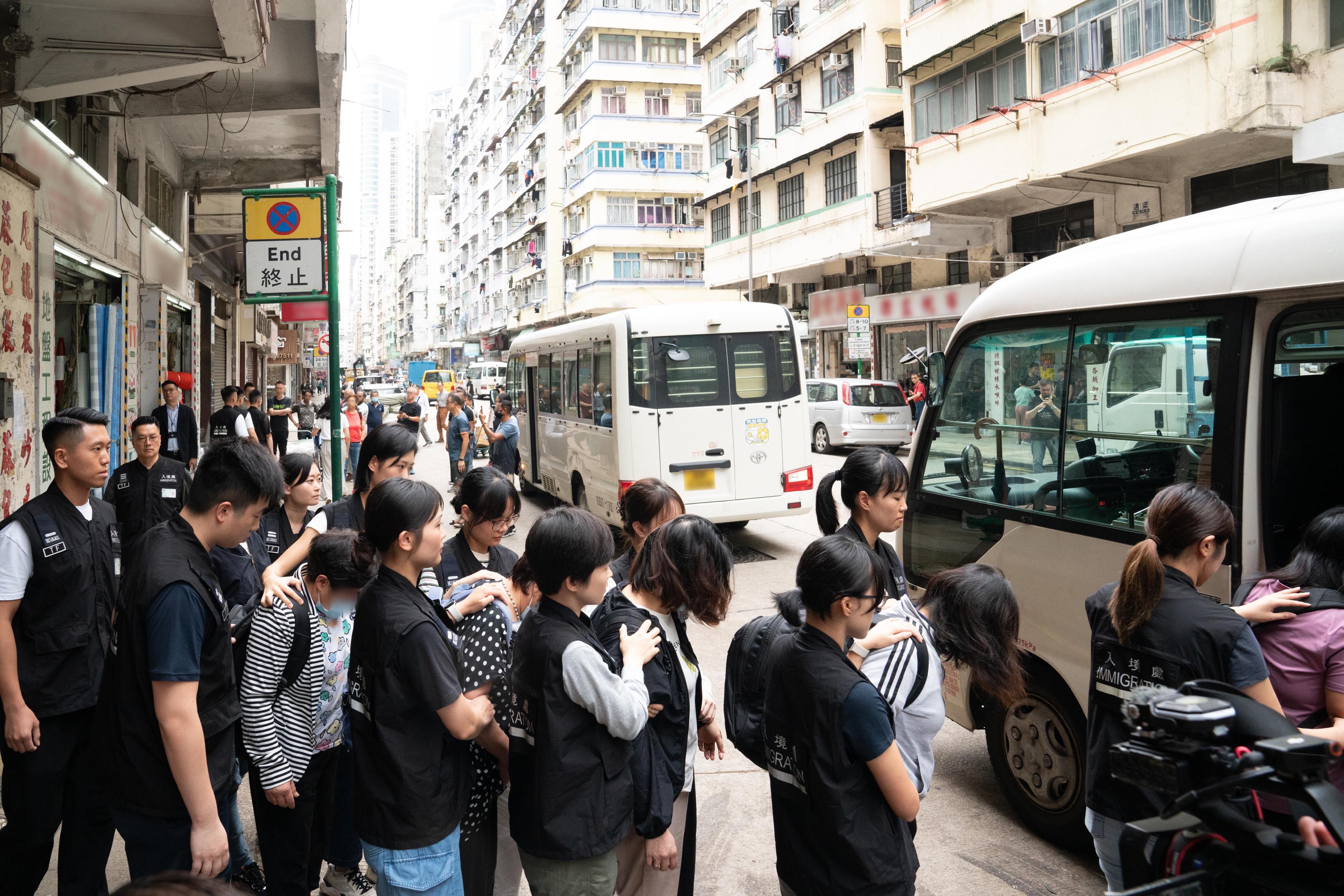 The Immigration Department mounted an anti-illegal worker operation in Yau Ma Tei District today (May 22). Photo shows suspected illegal workers arrested during the operation.