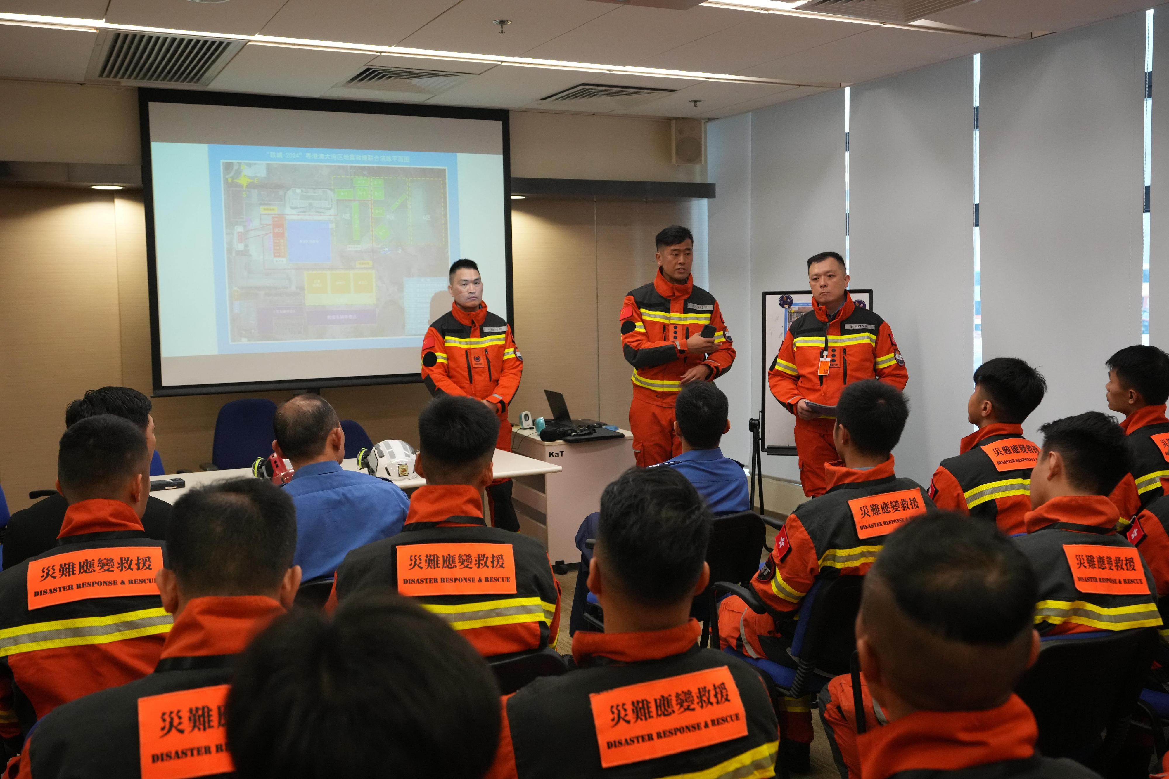 The Fire and Rescue Corps of Guangdong Province, the Hong Kong Fire Services Department (FSD) and the Macao Fire Services Bureau have conducted the Guangdong-Hong Kong-Macao Greater Bay Area joint emergency response and rescue exercise "Liancheng-2024" in Jiangmen, Guangdong Province from May 27 to today (May 29). Photo shows members of the Disaster Response and Rescue Team of the FSD listening to a briefing before departure at Kai Tak Fire Station.