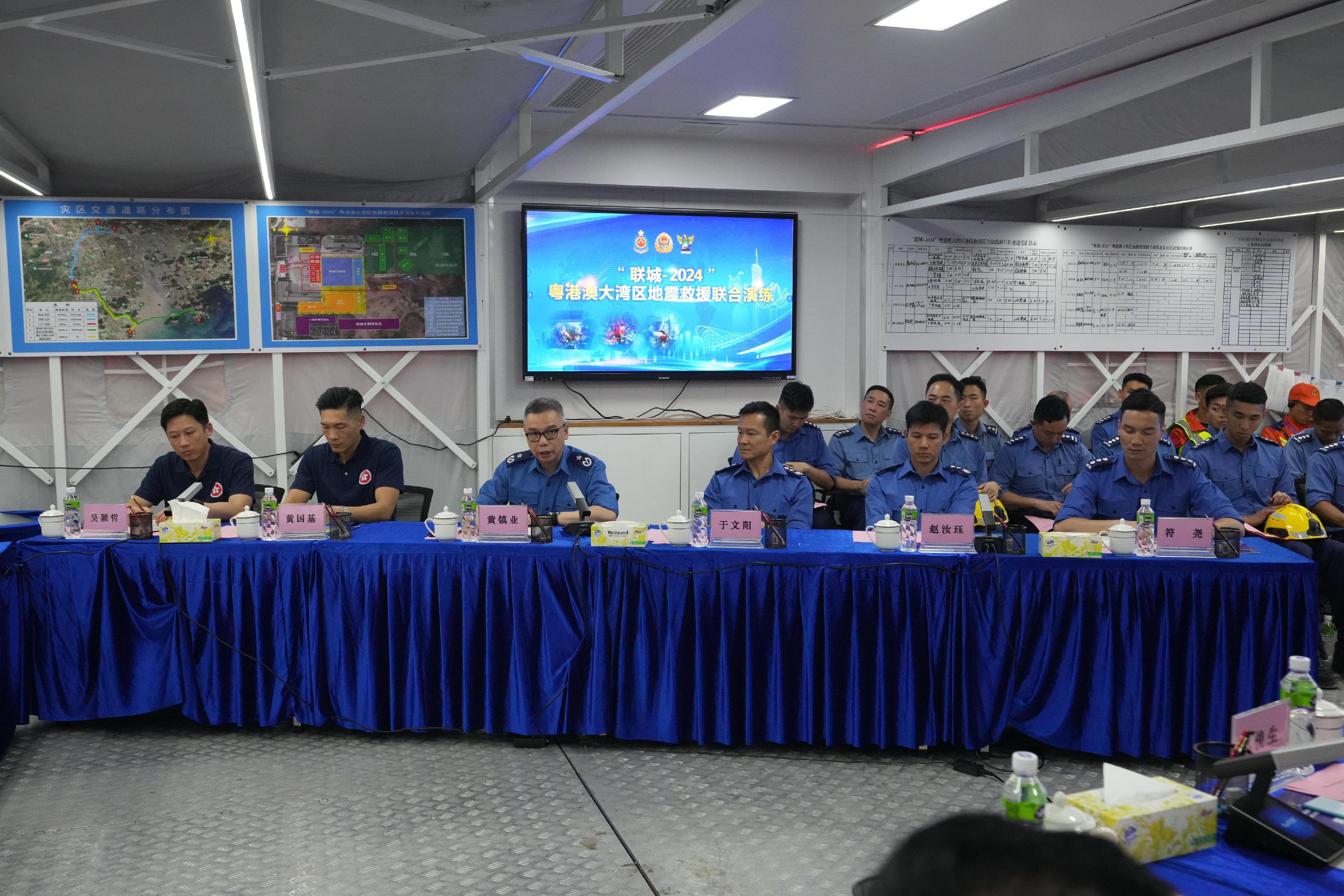 The Fire and Rescue Corps of Guangdong Province, the Hong Kong Fire Services Department and the Macao Fire Services Bureau have conducted the Guangdong-Hong Kong-Macao Greater Bay Area joint emergency response and rescue exercise "Liancheng-2024" in Jiangmen, Guangdong Province from May 27 to today (May 29). Photo shows the Deputy Director of Fire Services (Operations), Mr Angus Wong (third left), speaking at a command meeting.