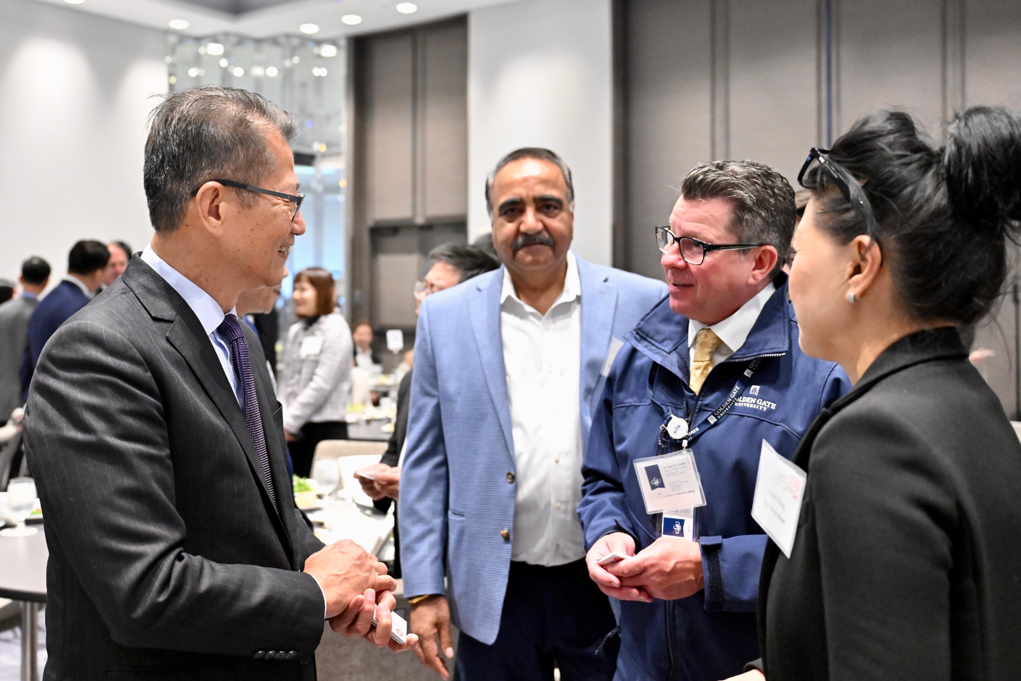 The Financial Secretary, Mr Paul Chan, began his visit to the United States on May 28 (San Francisco time), and attended a business luncheon jointly organised by the Hong Kong Economic and Trade Office in San Francisco and the Bay Area Council, a business organisation in San Francisco. Photo shows Mr Chan (first left) interacting with local guests at the luncheon.
