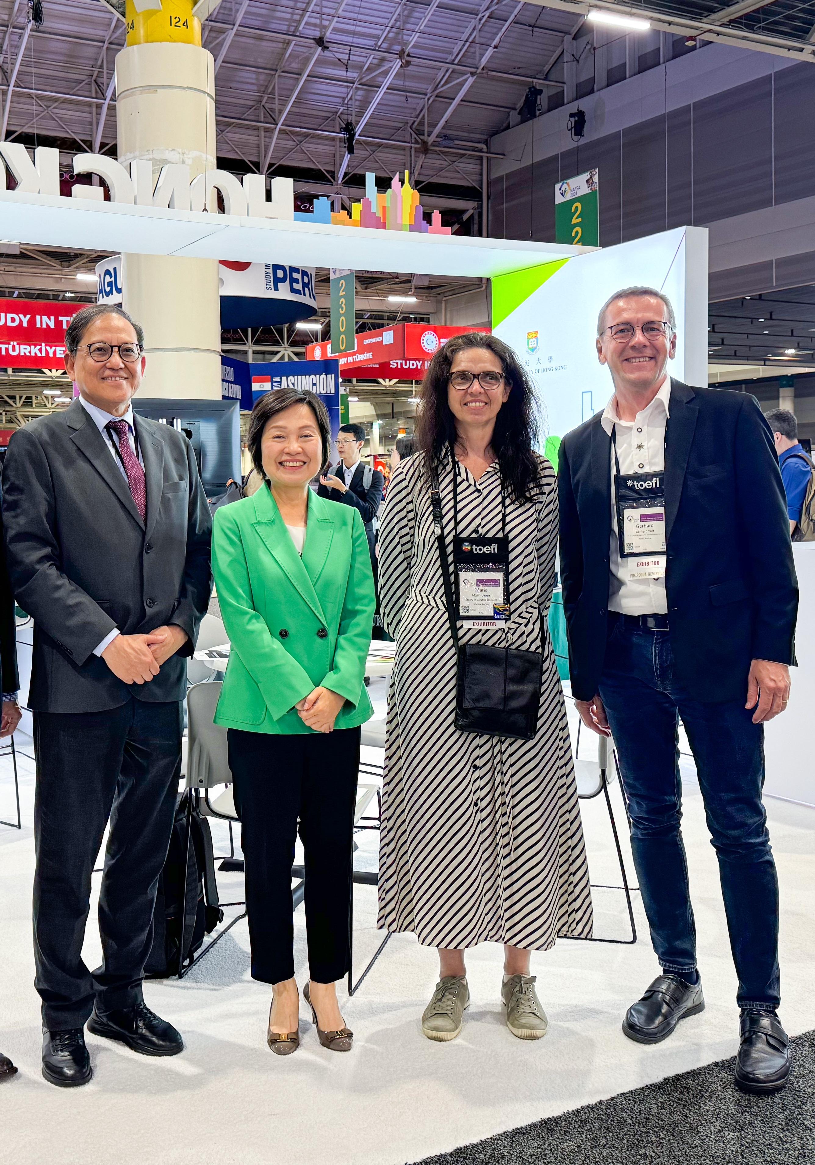 The Secretary for Education, Dr Choi Yuk-lin, visited booths of various countries and regions at the NAFSA Annual Conference & Expo in New Orleans, the United States, on May 29 (New Orleans time). Photo shows Dr Choi (second left) and the Secretary-General of the University Grants Committee, Professor James Tang (first left), with representatives of the Department for International Cooperation in Higher Education of Austria's Agency for Education and Internationalisation.  