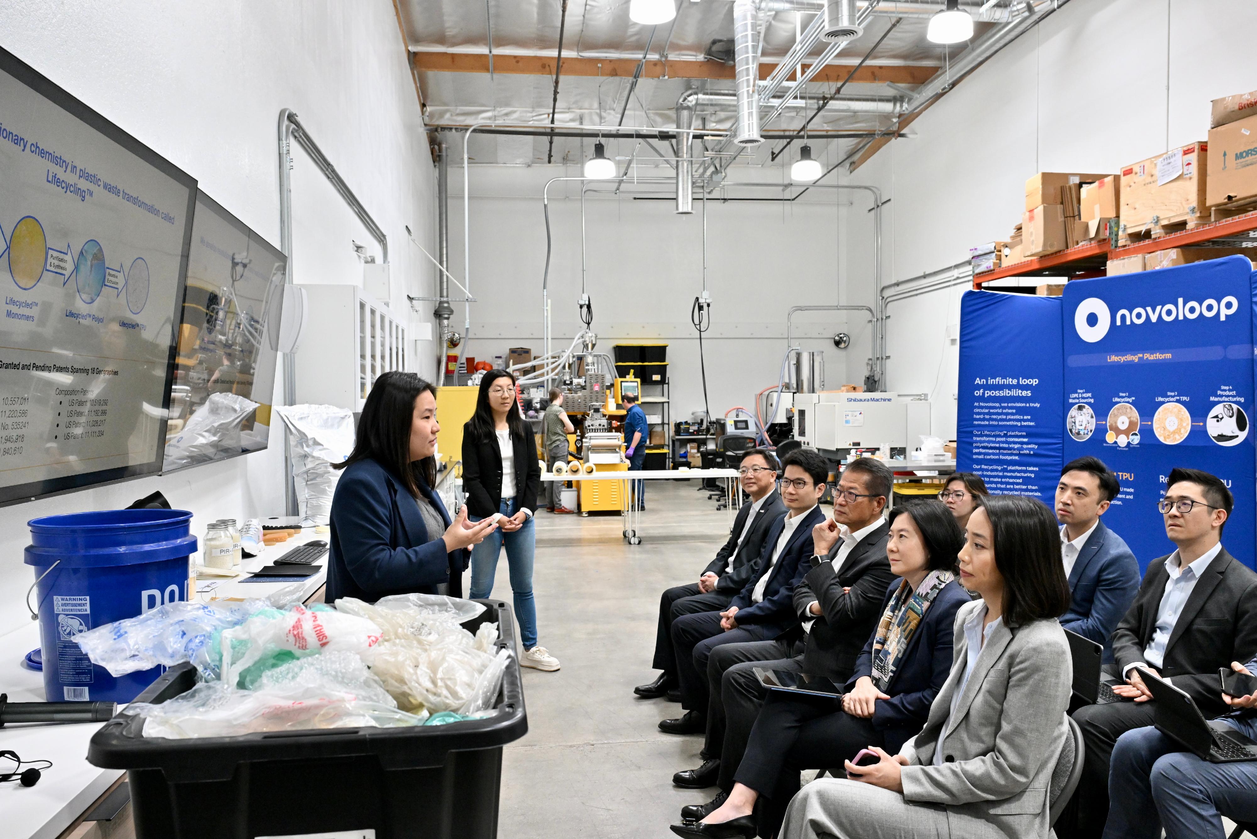 The Financial Secretary, Mr Paul Chan, visited a technology company engaged in plastic materials recycling for reuse in San Francisco, the United States, on May 30 (California time). Photo shows Mr Chan (sitting, from row, centre), being briefed by the founder and management of the technology company on their patented technology.