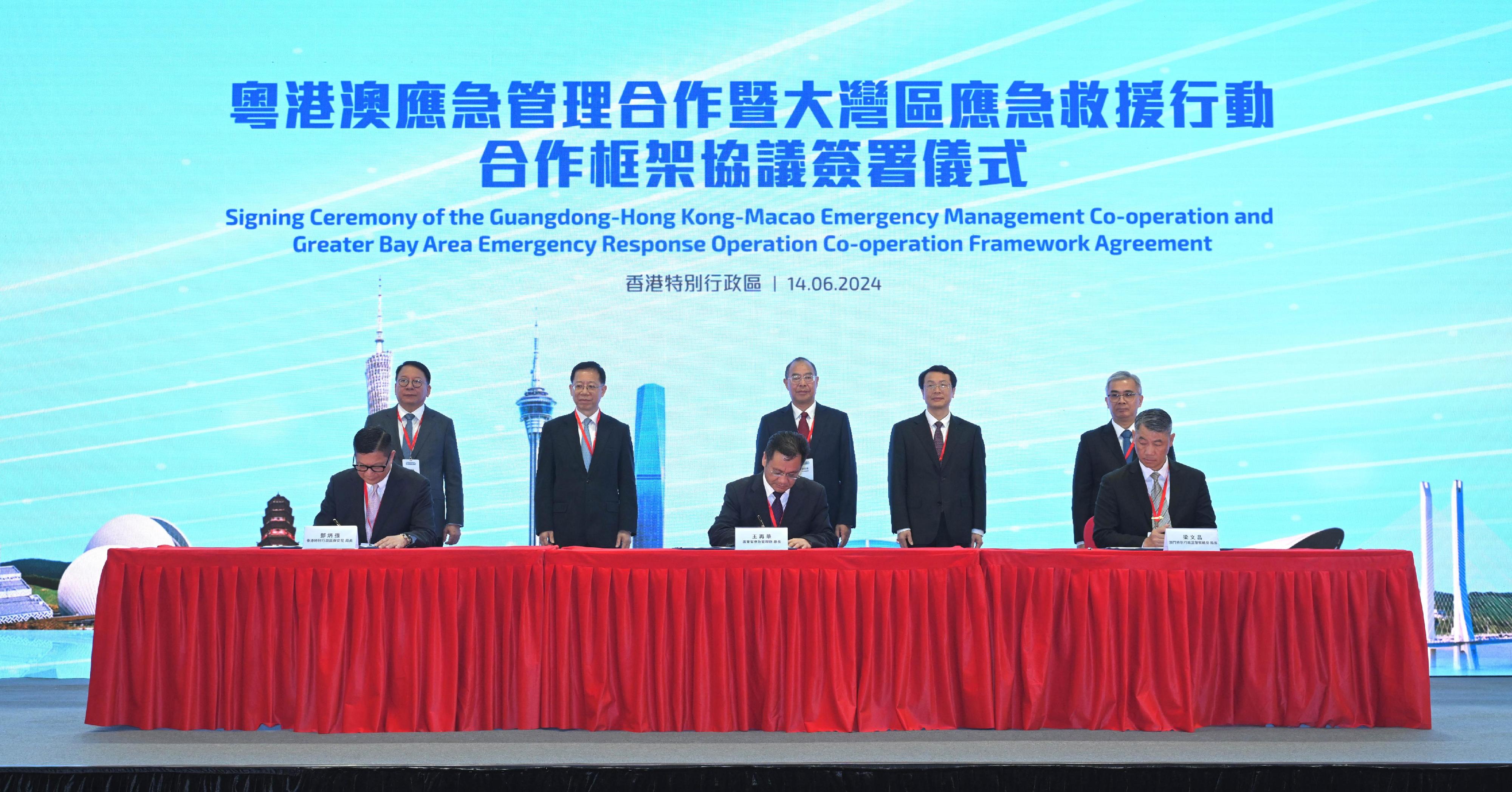 The People's Government of Guangdong Province, the Hong Kong Special Administrative Region (HKSAR) Government and the Macao Special Administrative Region (Macao SAR) Government signed the Guangdong-Hong Kong-Macao Emergency Management Co-operation and Greater Bay Area Emergency Response Operation Co-operation Framework Agreement in Hong Kong today (June 14). Photo shows (front row, from left) the Secretary for Security of the HKSAR, Mr Tang Ping-keung; the Director of the Department of Emergency Management of Guangdong Province, Mr Wang Zaihua; and the Commissioner General of the Unitary Police Service of the Macao SAR, Mr Leong Man-cheong signing the Framework Agreement on behalf of governments in the three places under the witness of (back row, from left) the Chief Secretary for Administration of the HKSAR, Mr Chan Kwok-ki; Member of the Office Leadership of the Hong Kong and Macao Affairs Office of the State Council Mr Xiang Bin; Vice Minister of the Ministry of Emergency Management Mr Xu Jia'ai; the Executive Vice-Governor of Guangdong Province, Mr Zhang Hu; and the Secretary for Security of the Macao SAR, Mr Wong Sio-chak.