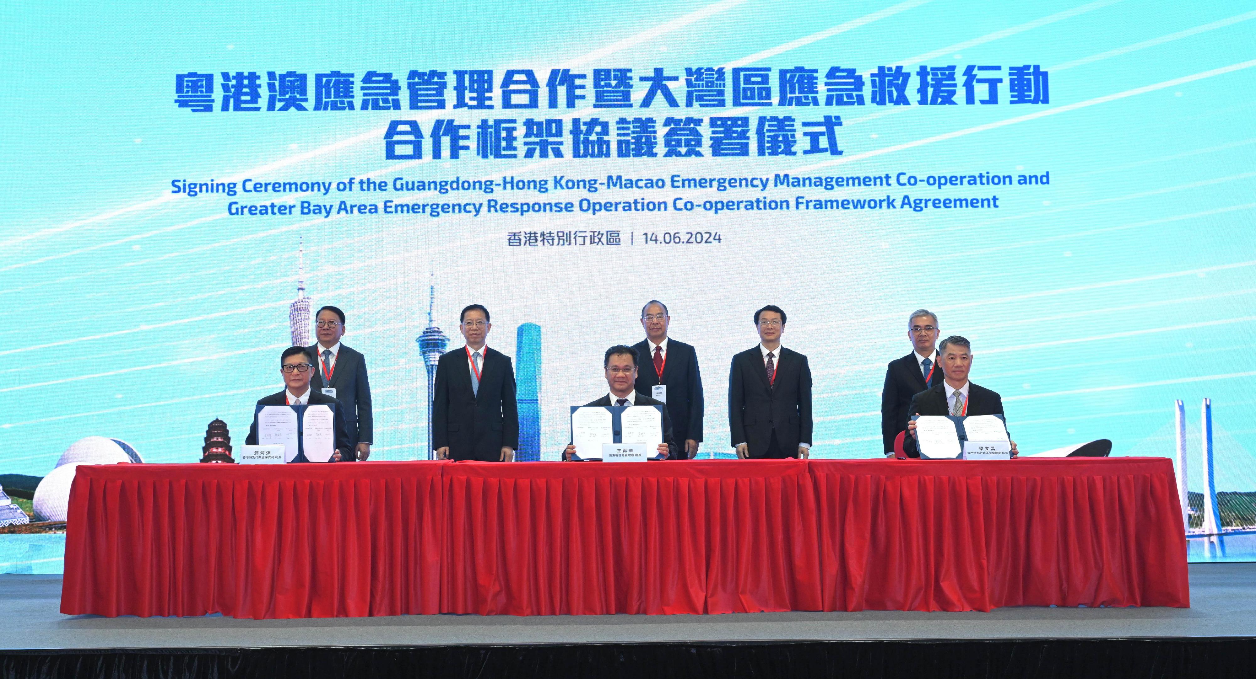 The People's Government of Guangdong Province, the Hong Kong Special Administrative Region (HKSAR) Government and the Macao Special Administrative Region (Macao SAR) Government signed the Guangdong-Hong Kong-Macao Emergency Management Co-operation and Greater Bay Area Emergency Response Operation Co-operation Framework Agreement in Hong Kong today (June 14). Photo shows (front row, from left) the Secretary for Security of the HKSAR, Mr Tang Ping-keung; the Director of the Department of Emergency Management of Guangdong Province, Mr Wang Zaihua; and the Commissioner General of the Unitary Police Service of the Macao SAR, Mr Leong Man-cheong signing the Framework Agreement on behalf of governments in the three places under the witness of (back row, from left) the Chief Secretary for Administration of the HKSAR, Mr Chan Kwok-ki; Member of the Office Leadership of the Hong Kong and Macao Affairs Office of the State Council Mr Xiang Bin; Vice Minister of the Ministry of Emergency Management Mr Xu Jia'ai; the Executive Vice-Governor of Guangdong Province, Mr Zhang Hu; and the Secretary for Security of the Macao SAR, Mr Wong Sio-chak.