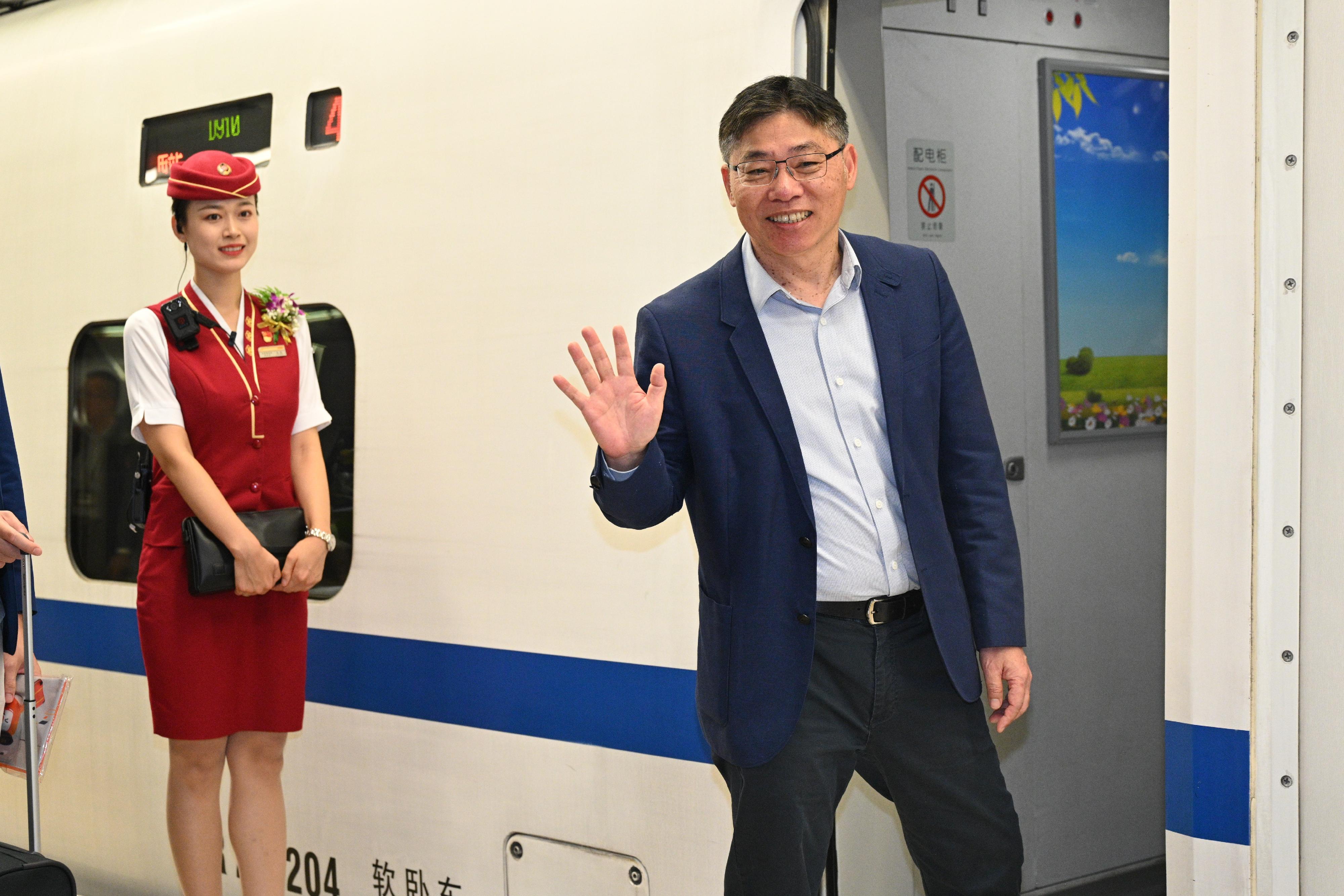 The Secretary for Transport and Logistics, Mr Lam Sai-hung (right), takes the inaugural sleeper train of the Guangzhou-Shenzhen-Hong Kong Express Rail Link from the Hong Kong West Kowloon Station to the Beijingxi Station at dusk today (June 15).
