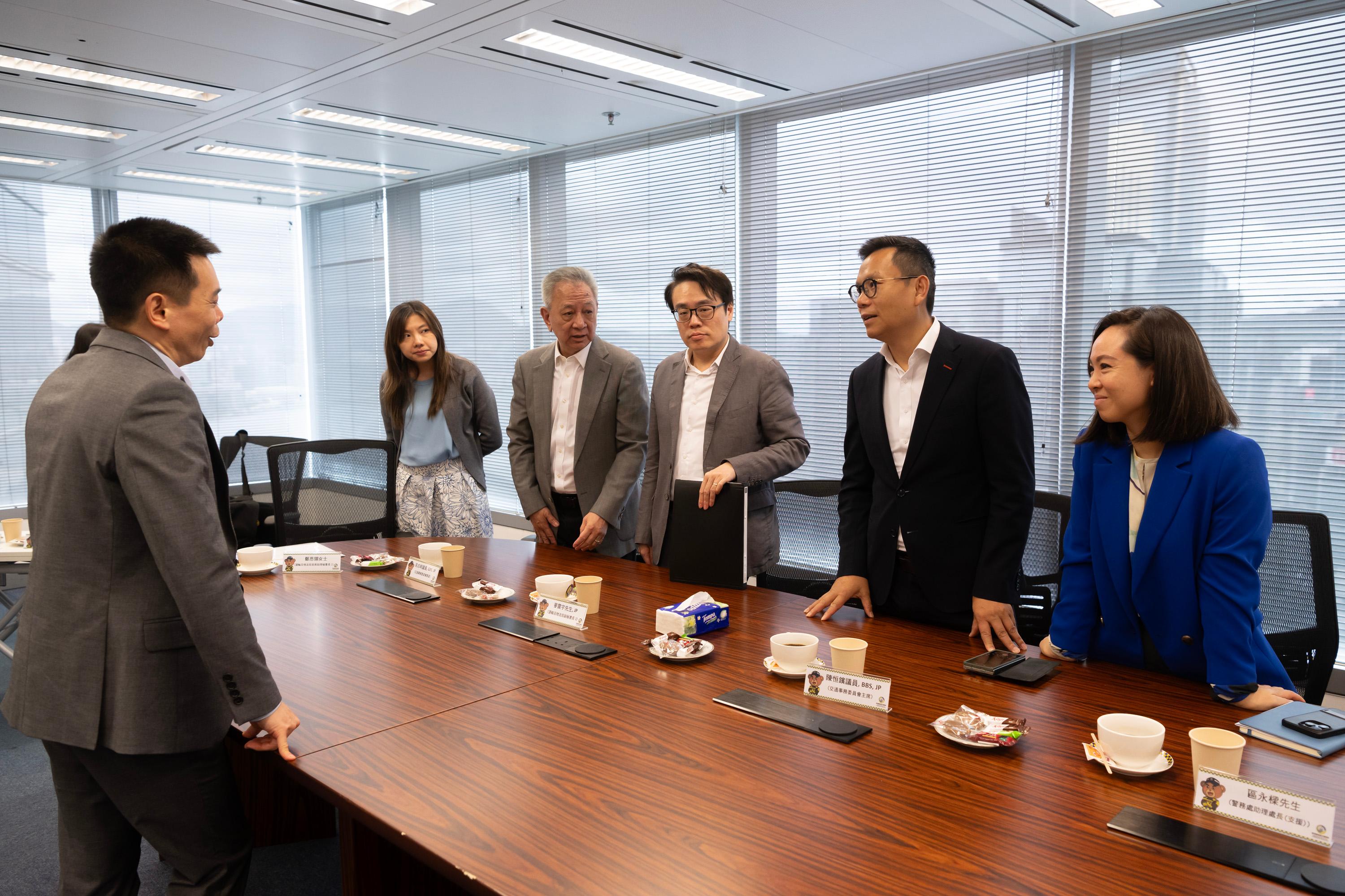 The Legislative Council Panel on Transport observes the demonstration of functions of eTraffic Ticket Platform at the Police Headquarters today (June 24).  Photo shows the Chairman of the Panel on Transport, Dr Chan Han-pan (second right), and other Members exchanging views with representatives of the Transport and Logistics Bureau and the Police on the workflow of serving electronic fixed penalty notices and demand notices.