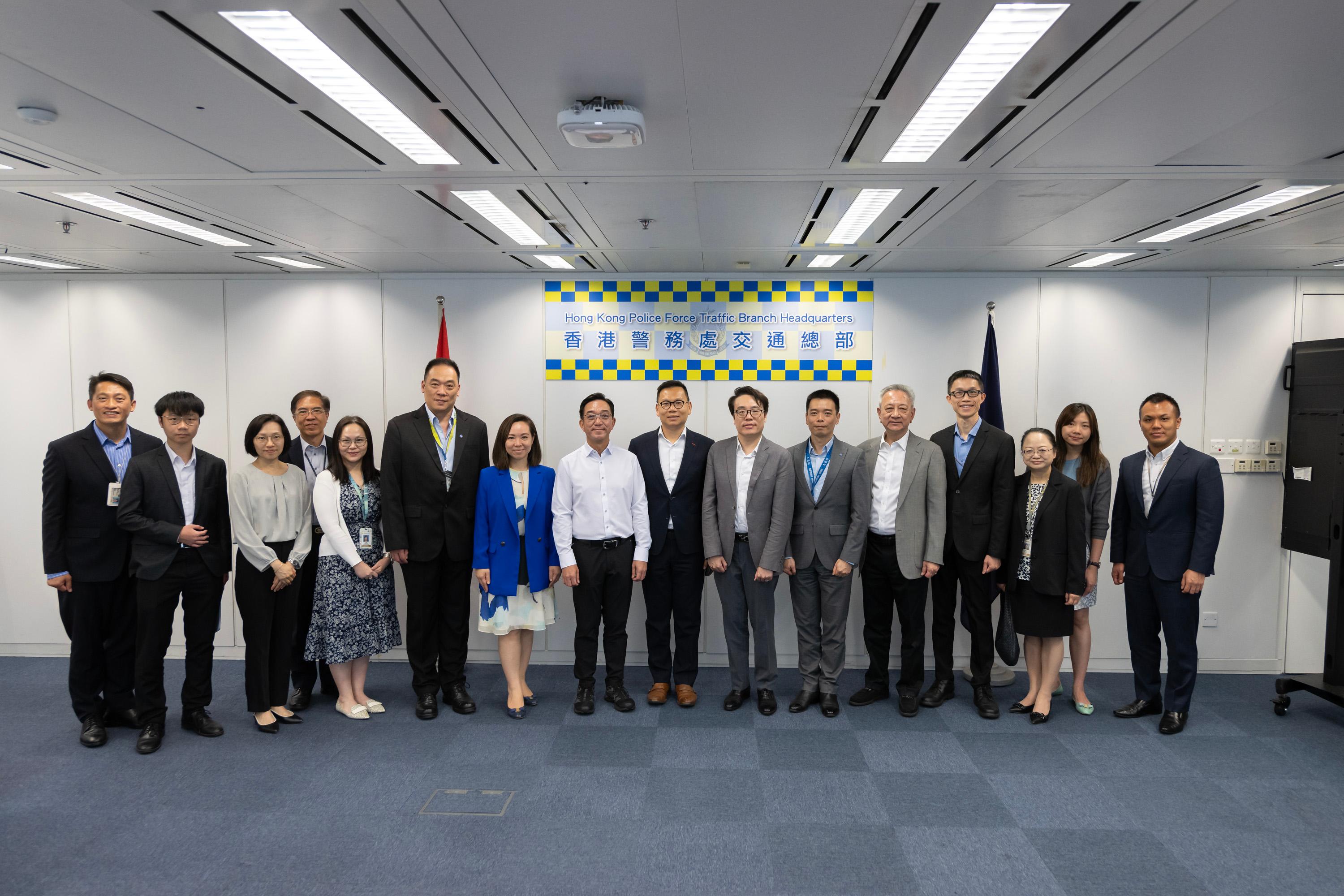 The Legislative Council (LegCo) Panel on Transport observes the demonstration of functions of eTraffic Ticket Platform at the Police Headquarters today (June 24).  Photo shows LegCo members and representatives of the Transport and Logistics Bureau and the Police posing for a group photo at the Police Headquarters.