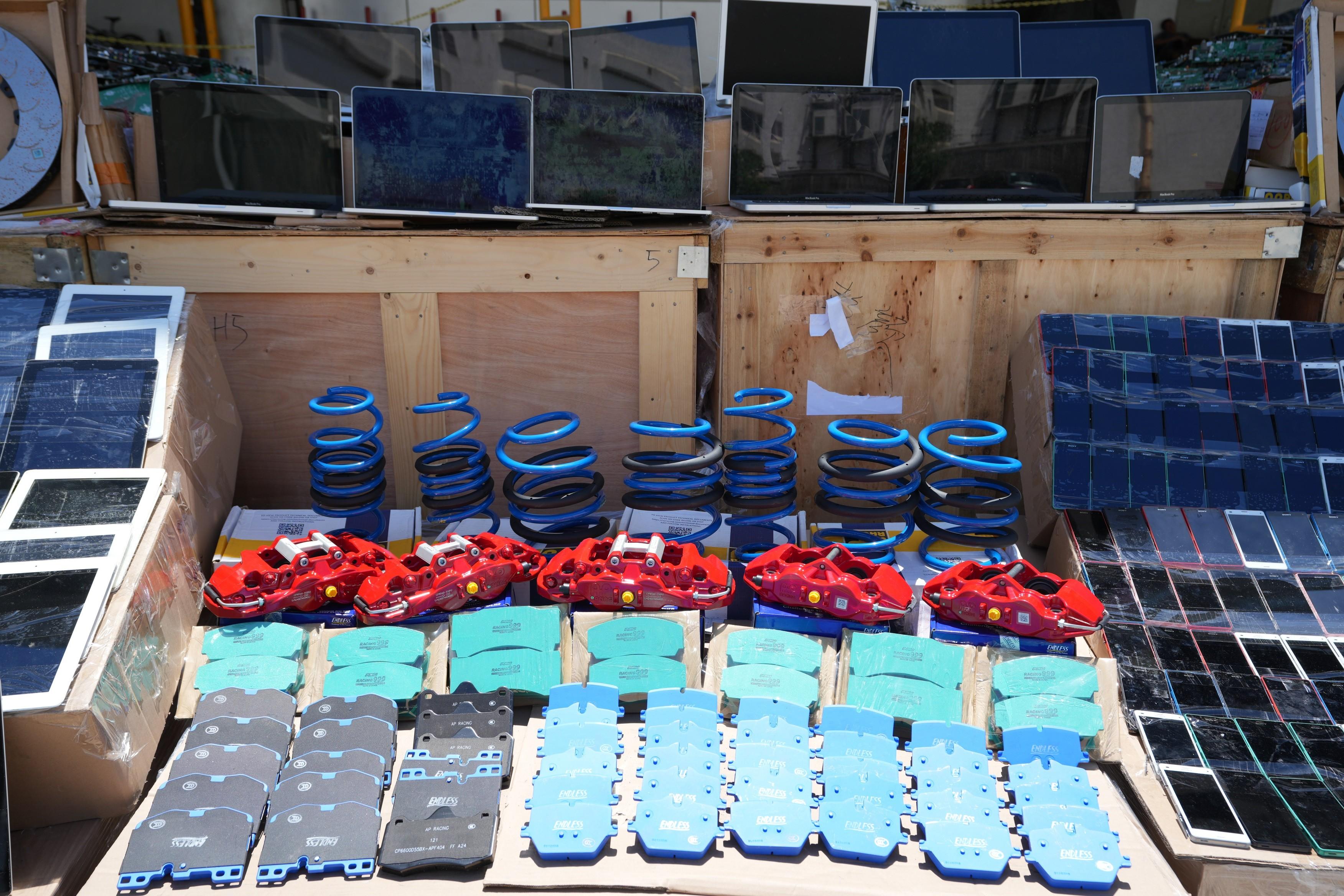 Hong Kong Customs mounted a special operation codenamed "Big Wave" in June and detected three suspected smuggling cases involving ocean-going vessels. A large batch of suspected smuggled goods with a total estimated market value of about $100 million was seized. Photo shows some of the suspected smuggled car parts seized.