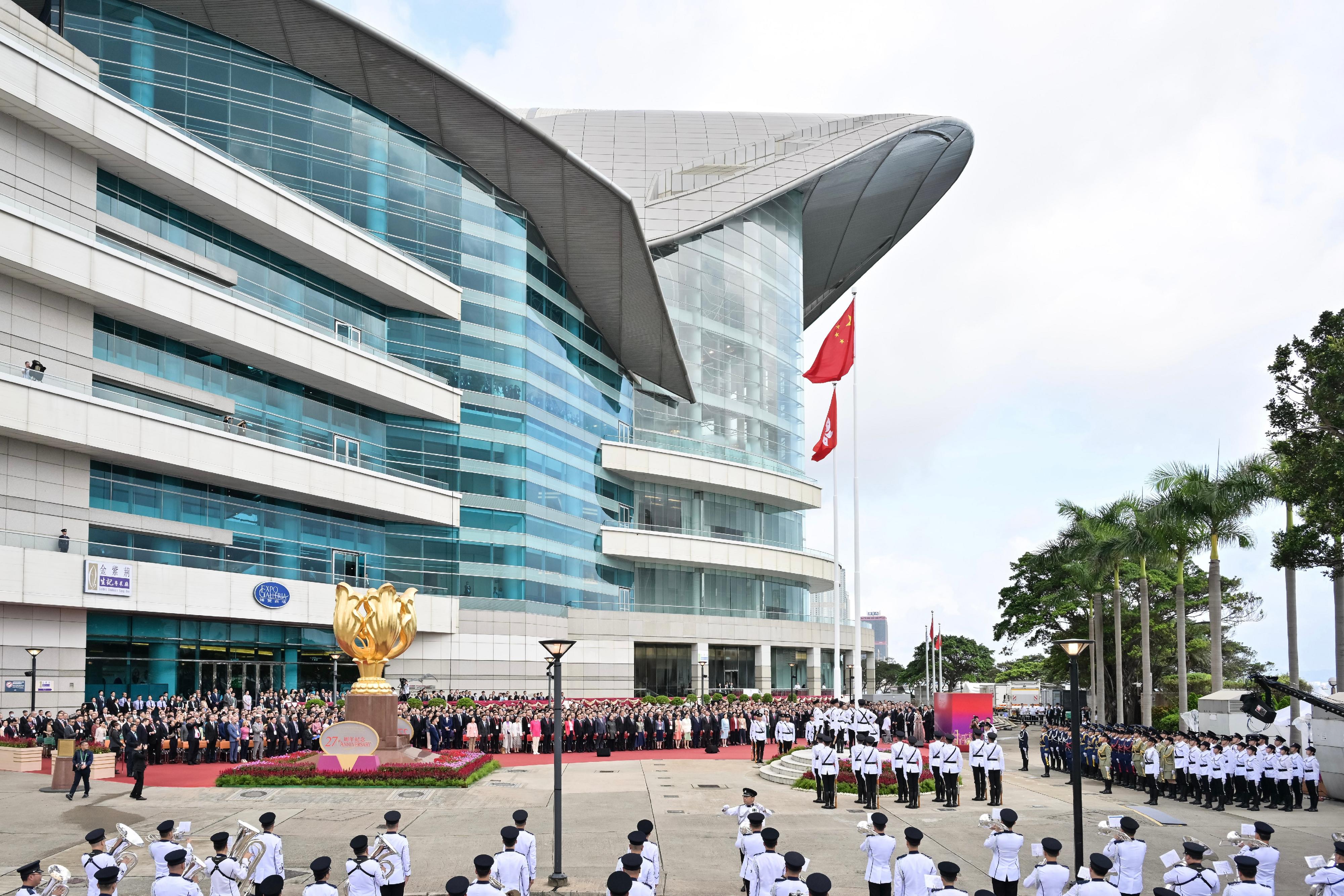 The Chief Executive, Mr John Lee, together with Principal Officials and guests, attends the flag-raising ceremony for the 27th anniversary of the establishment of the Hong Kong Special Administrative Region at Golden Bauhinia Square in Wan Chai this morning (July 1).