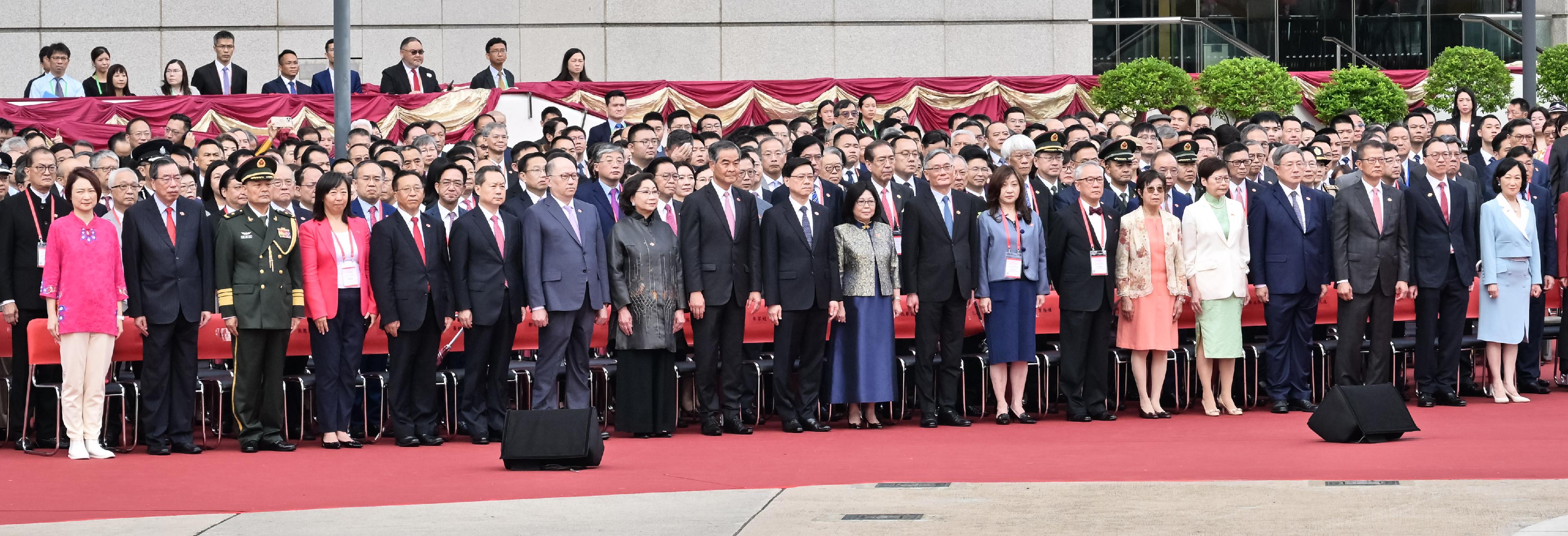 The Chief Executive, Mr John Lee (front row, 10th left), and his wife (front row, 10th right); the Chief Justice of the Court of Final Appeal, Mr Andrew Cheung Kui-nung (front row, 9th right), and his wife (front row, 8th right); former CE Mr Donald Tsang (front row, 7th right), and his wife (front row, 6th right); Vice-Chairman of the National Committee of the CPPCC Mr C Y Leung (front row, 9th left), and his wife (front row, 8th left); former CE Mrs Carrie Lam (front row, 5th right); the Director of the LOCPG in the HKSAR, Mr Zheng Yanxiong (front row, 7th left); the Head of the Office for Safeguarding National Security of the CPG in the HKSAR, Mr Dong Jingwei (front row, 6th left); the Commissioner of the Ministry of Foreign Affairs in the HKSAR, Mr Cui Jianchun (front row, 5th left), and his wife (front row, 4th left); the Commander-in-chief of the CPLA Hong Kong Garrison, Major General Peng Jingtang (front row, 3rd left); the Acting Chief Secretary for Administration, Mr Cheuk Wing-hing (front row, 4th right); the Financial Secretary, Mr Paul Chan (front row, 3rd right); the Secretary for Justice, Mr Paul Lam, SC (front row, 2nd right); the President of the LC, Mr Andrew Leung (front row, 2nd left); the Convenor of the Non-official Members of the ExCo, Mrs Regina Ip (front row, 1st right), together with Principal Officials and guests, attend the flag-raising ceremony for the 27th anniversary of the establishment of the HKSAR at Golden Bauhinia Square in Wan Chai this morning (July 1).