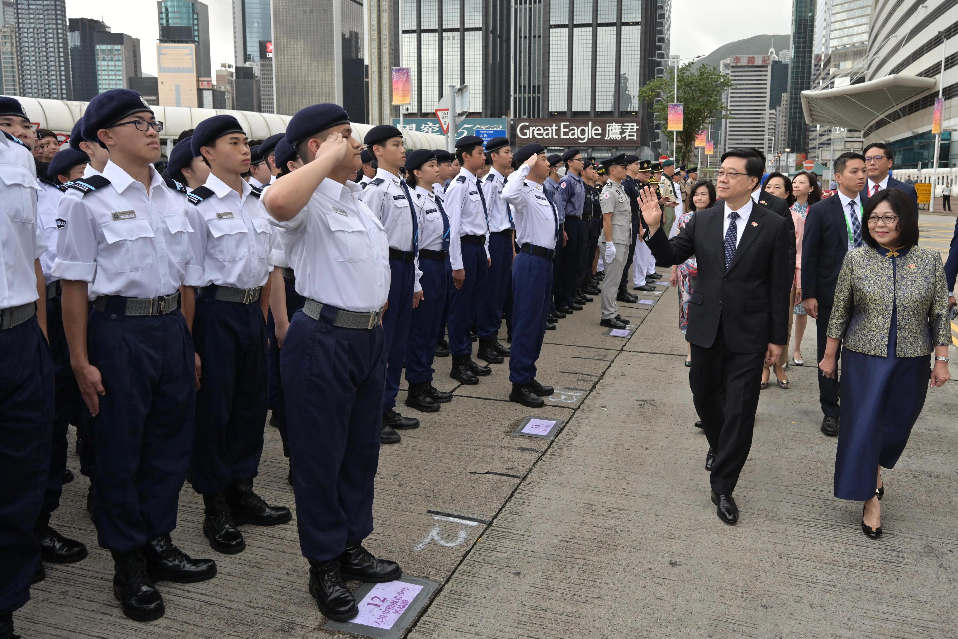 The Chief Executive, Mr John Lee, together with Principal Officials and guests, attended the flag-raising ceremony for the 27th anniversary of the establishment of the Hong Kong Special Administrative Region at Golden Bauhinia Square in Wan Chai this morning (July 1). Photo shows Mr Lee (second right) receiving salute by uniformed groups.