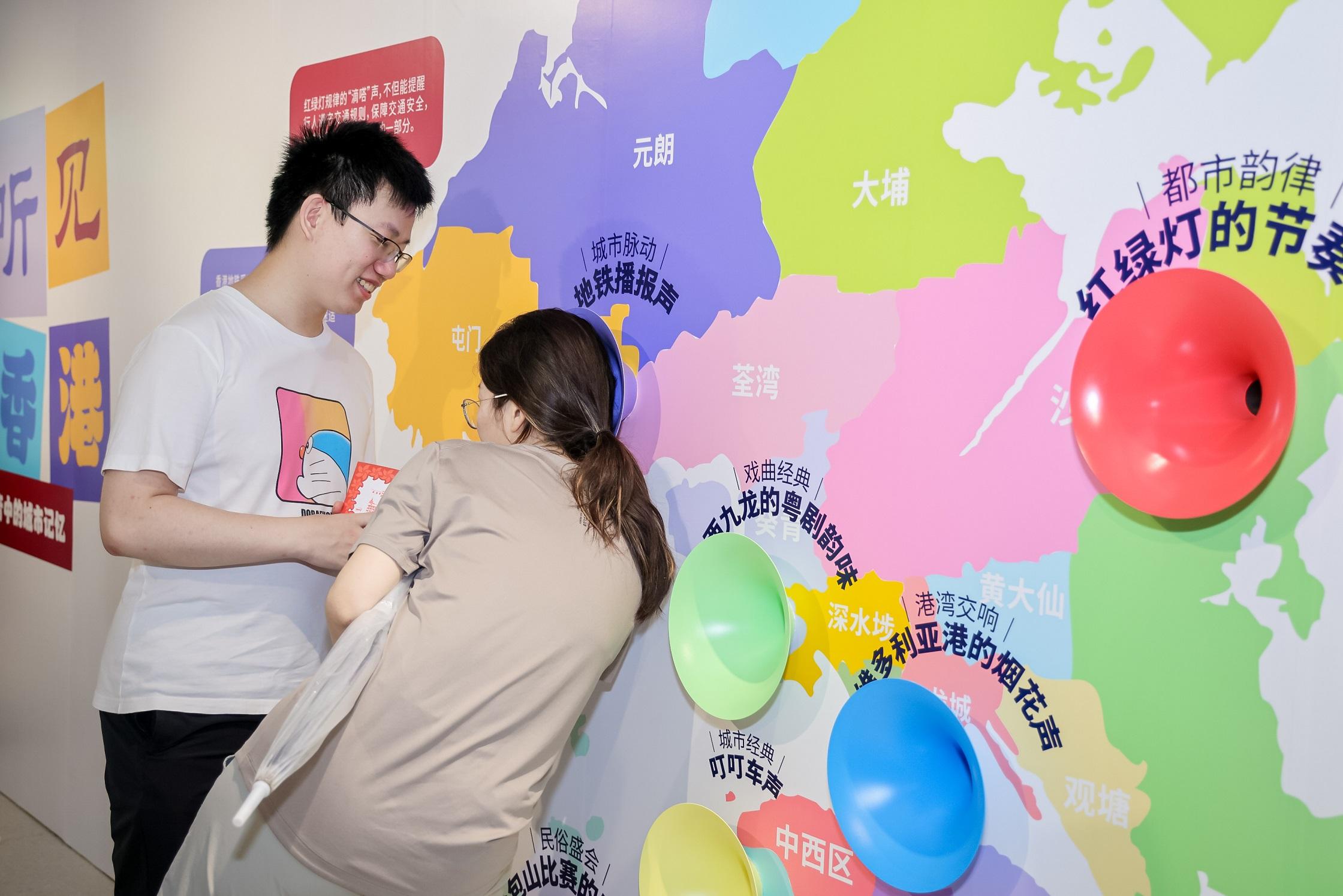 To celebrate the 27th anniversary of the establishment of the Hong Kong Special Administrative Region, the Hong Kong Economic and Trade Office in Shanghai (SHETO) unveiled a series of diverse events today (July 1) in Shanghai to encourage Mainland citizens to experience the joy of Hong Kong's return to the motherland. Photo shows citizens touring an exhibition held by SHETO with the theme of "Fun in Hong Kong", and to have a taste on Hong Kong's diversity and fresh new travel experiences.